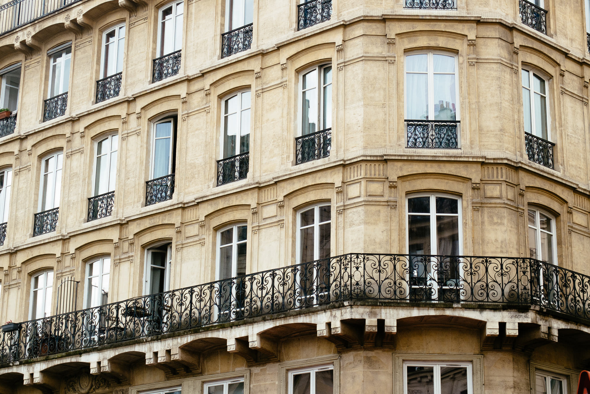 Parisian building facade with ornate balconies.