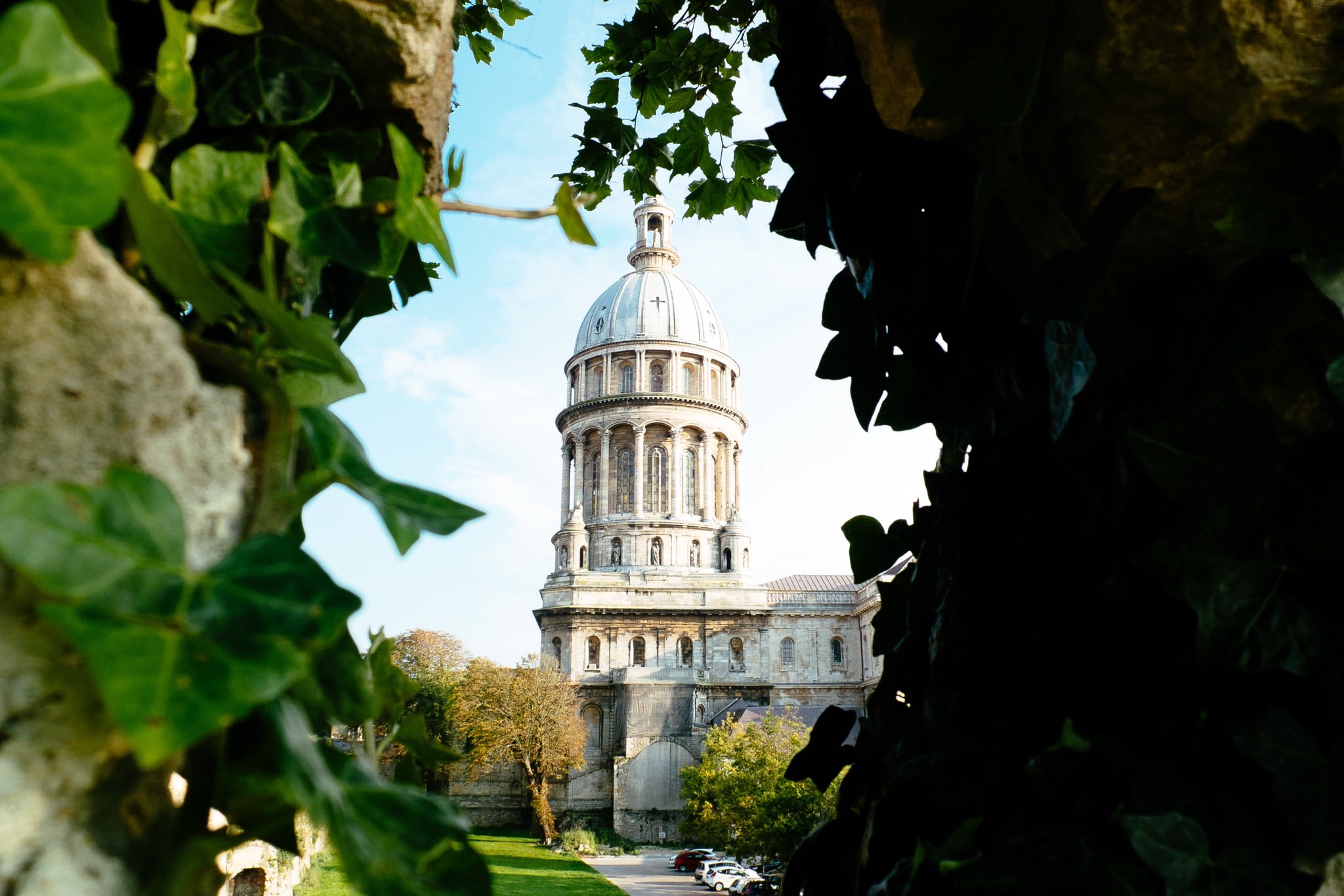 Basilica of Notre-Dame de Boulogne viewed through foliage.