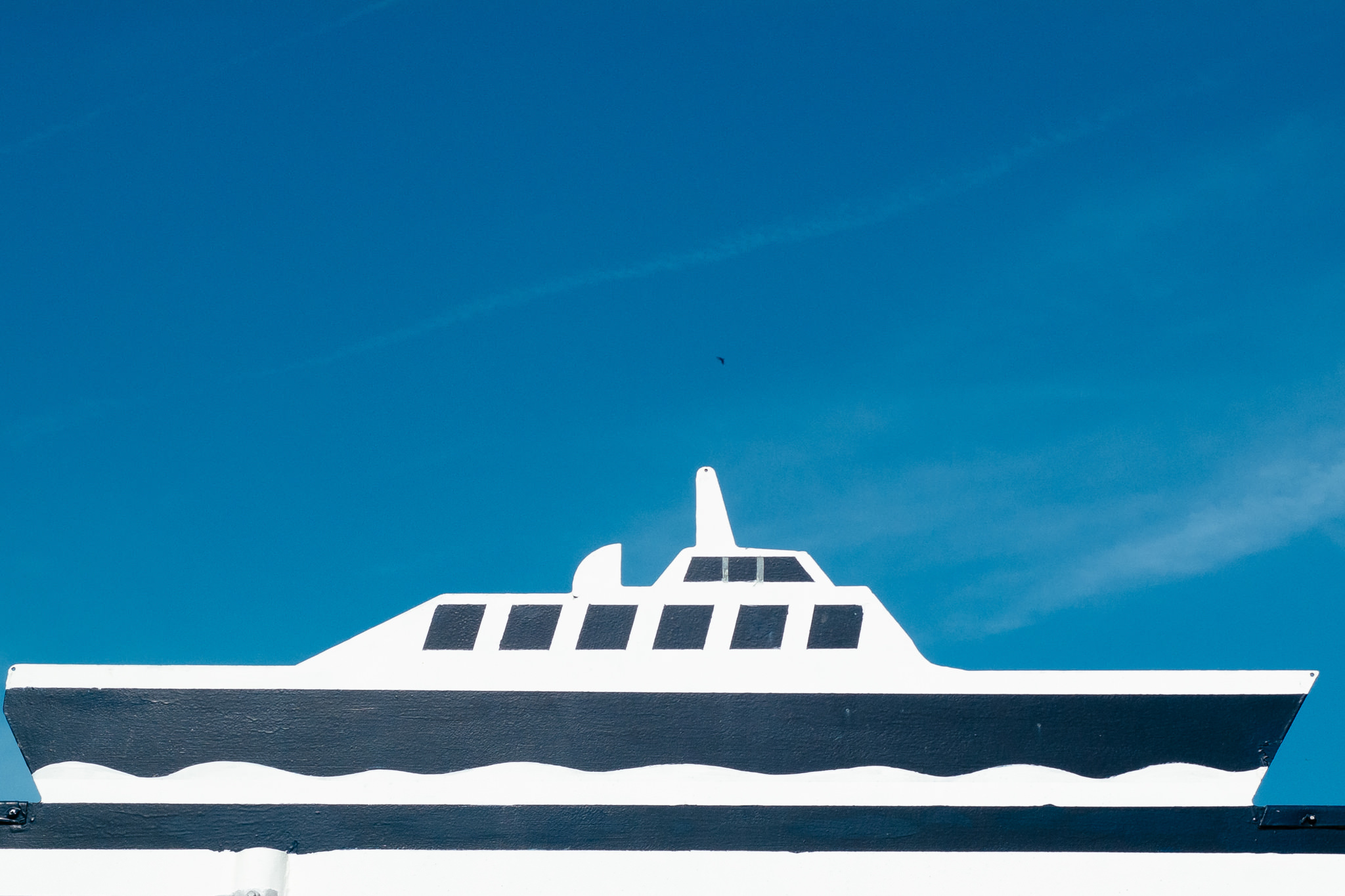 Boat sign against a blue sky.