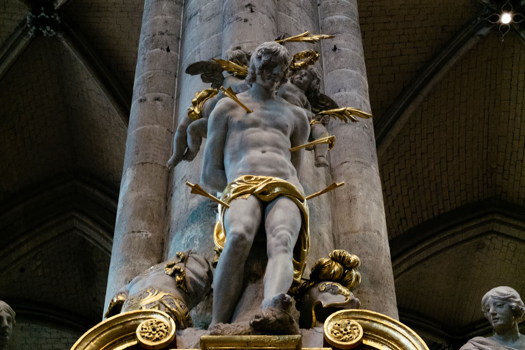 Statue of Saint Sebastian pierced by arrows in Amiens Cathedral, France.
