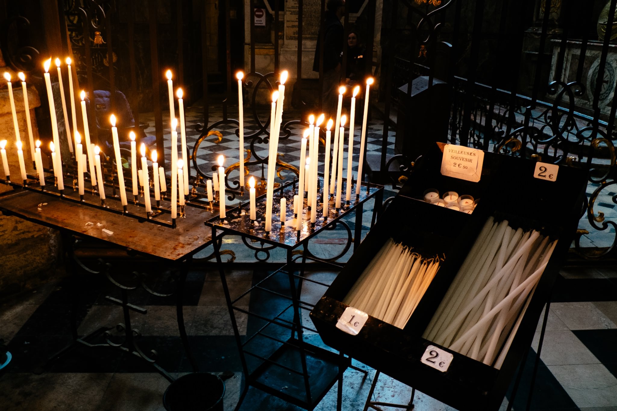 Lit candles on stands in Amiens Cathedral, France.