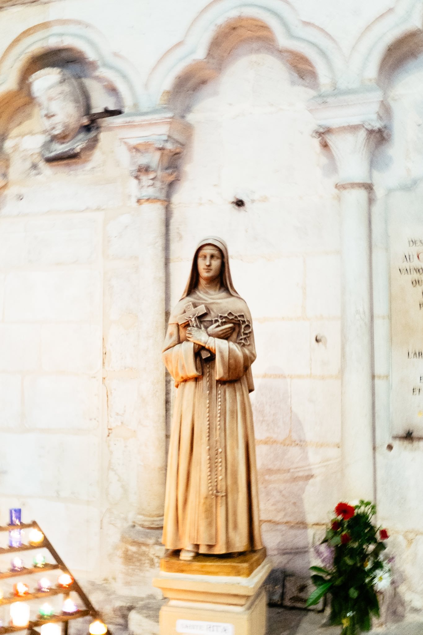 Statue of a nun holding a cross in Amiens Cathedral, France.