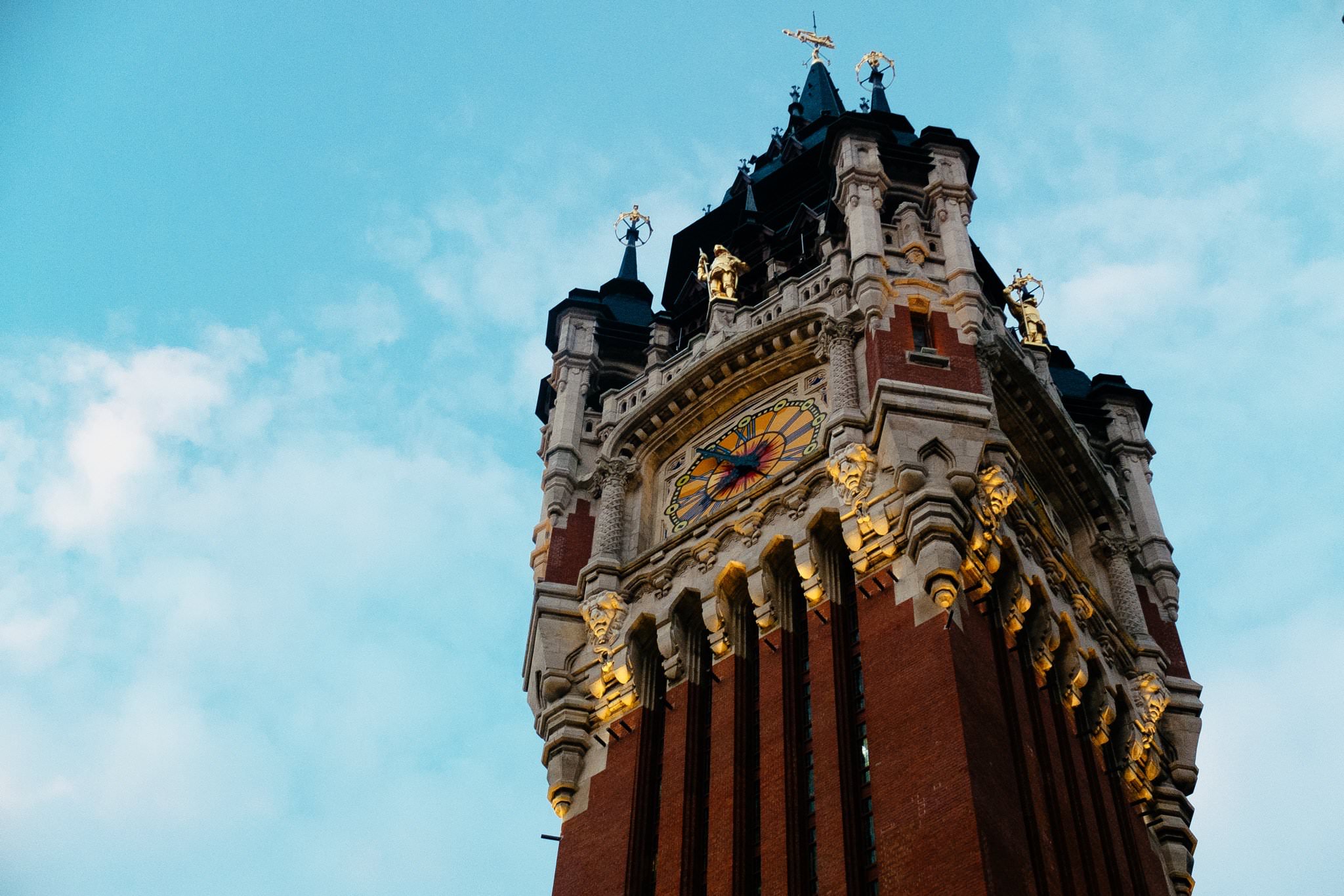 Calais, France clock tower with ornate details and clock face.