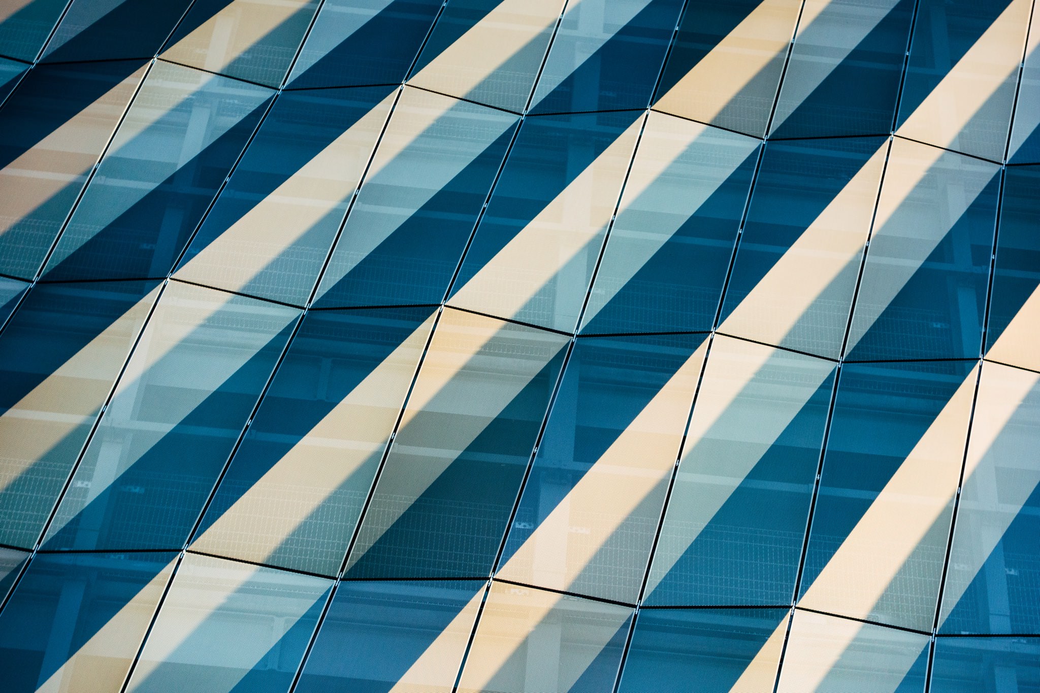 Abstract diagonal pattern of blue and beige panels.