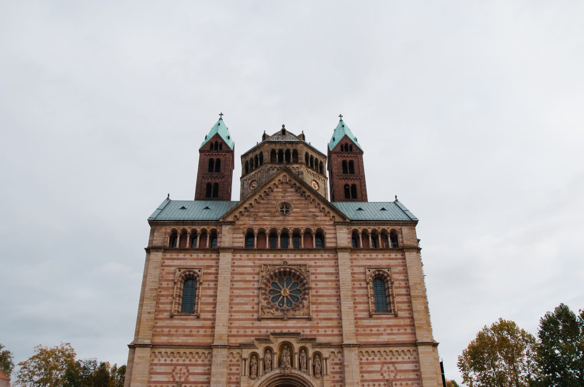 Speyer Cathedral facade with twin towers and rose window.