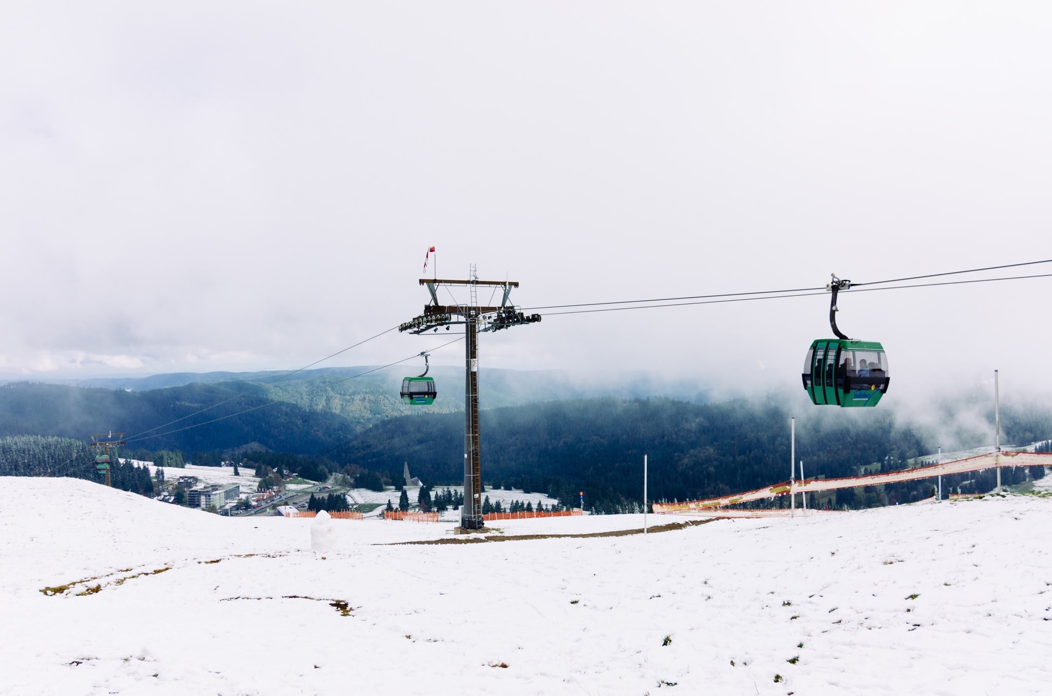 Snow-covered Feldbergbahn lift in the Black Forest with two cable cars.