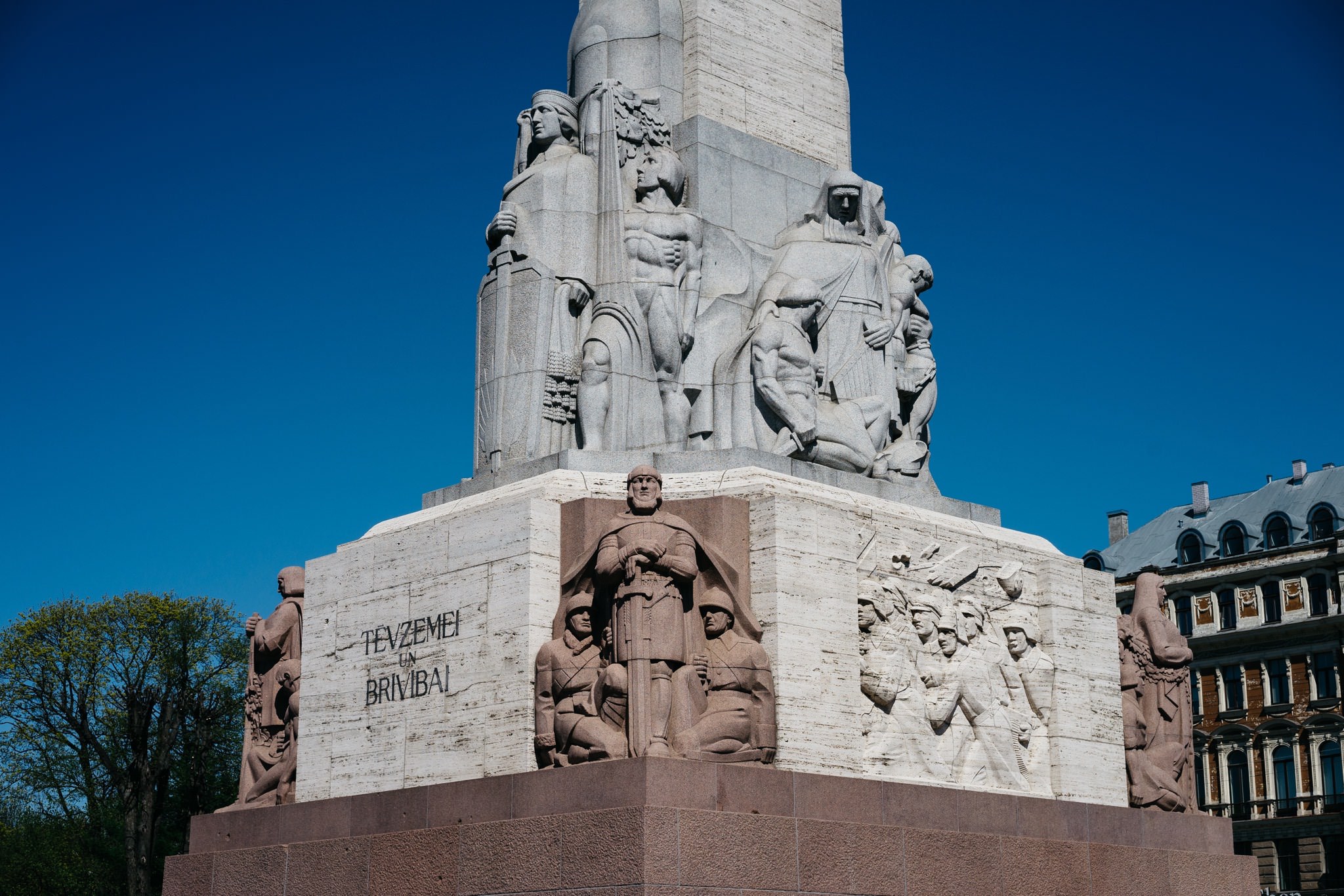 Close-up of the Freedom Monument in Riga, Latvia, showcasing detailed stone carvings.