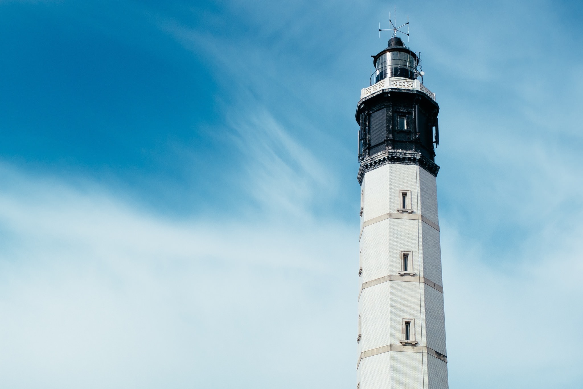 Calais lighthouse, France, against a blue sky.