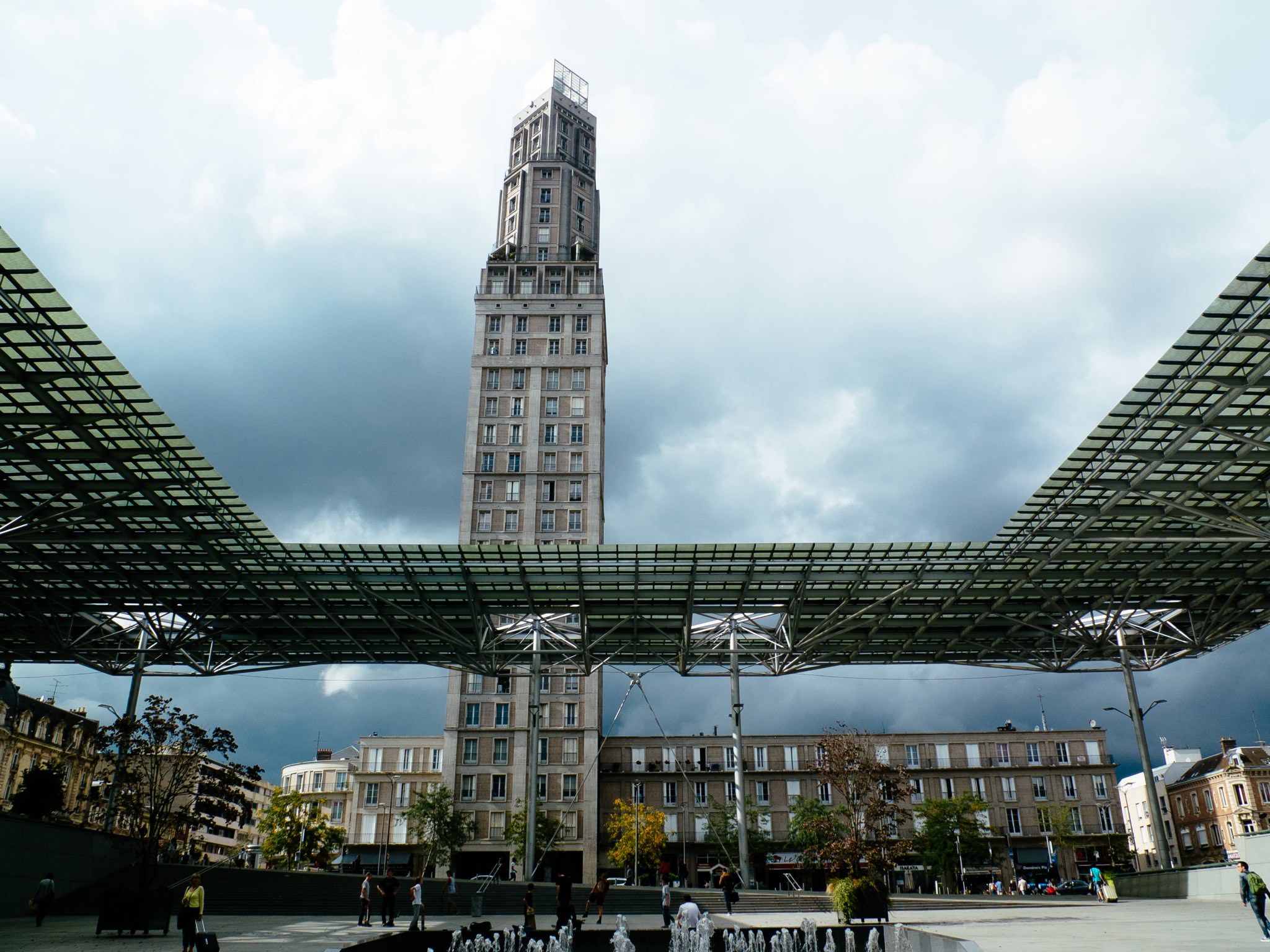 Amiens, France: Modern architecture with a tall tower and a glass-roofed plaza.