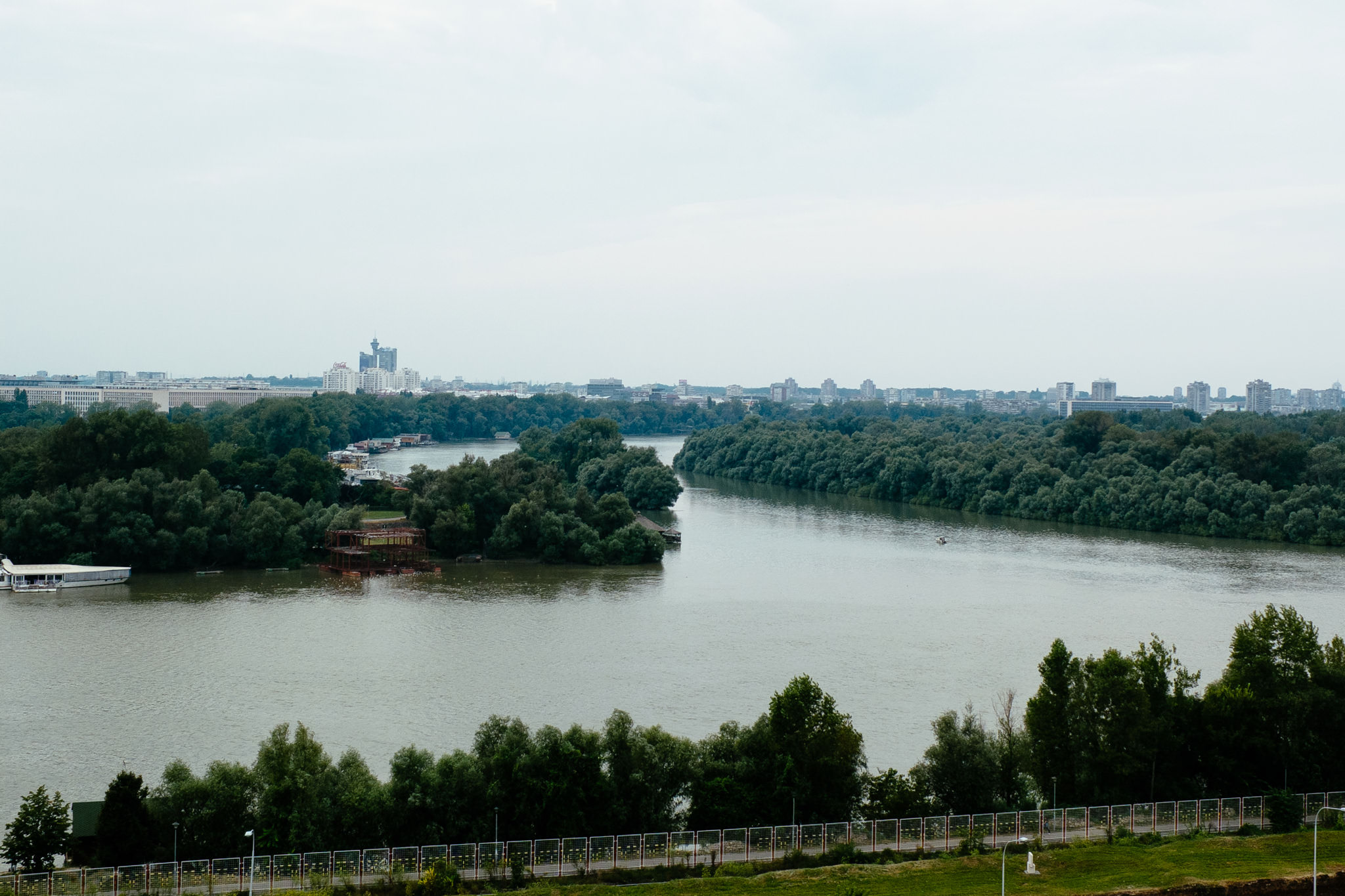 Aerial view of the Sava River in Belgrade, Serbia, with a cityscape in the background.