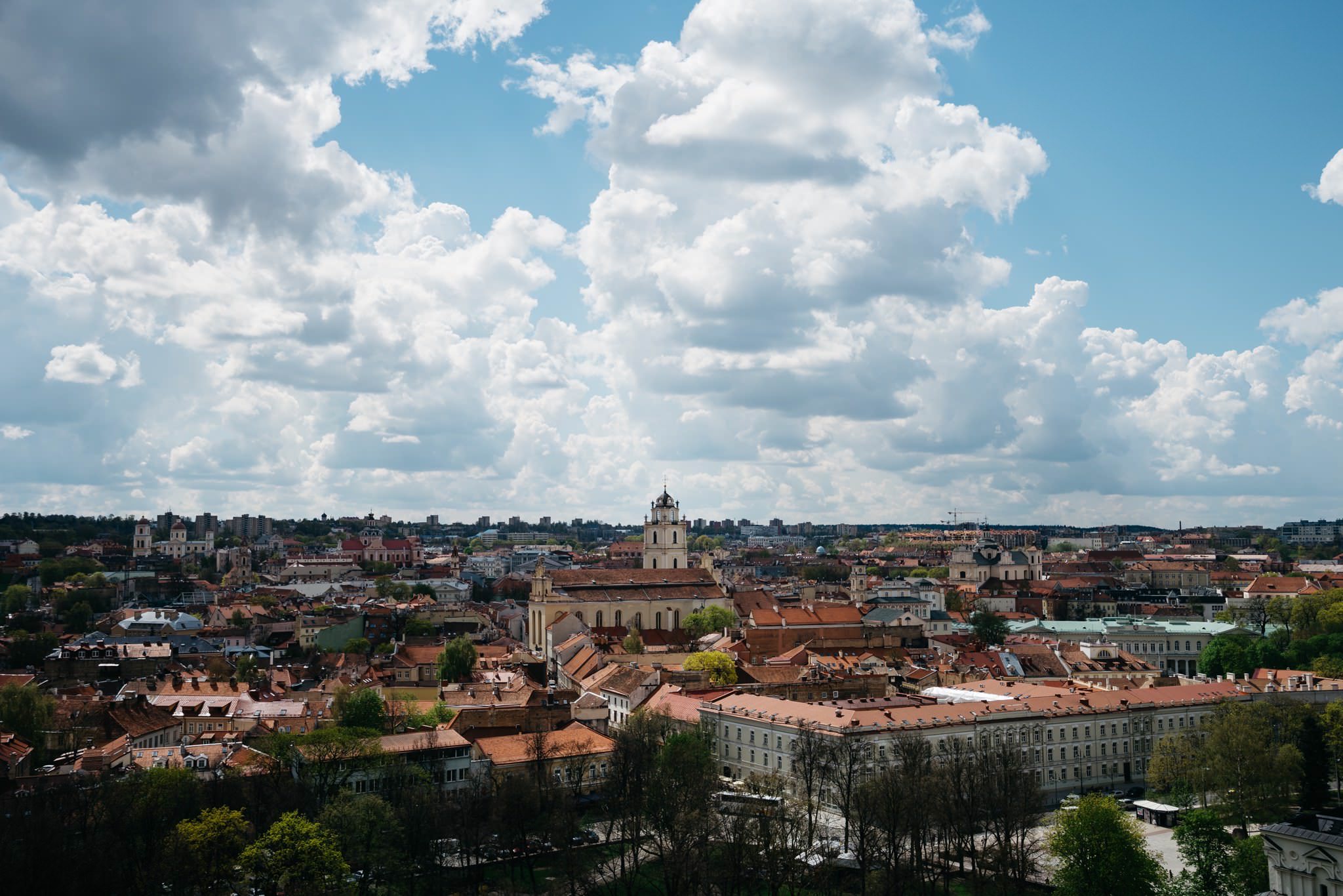 Vilnius skyline under a partly cloudy sky.