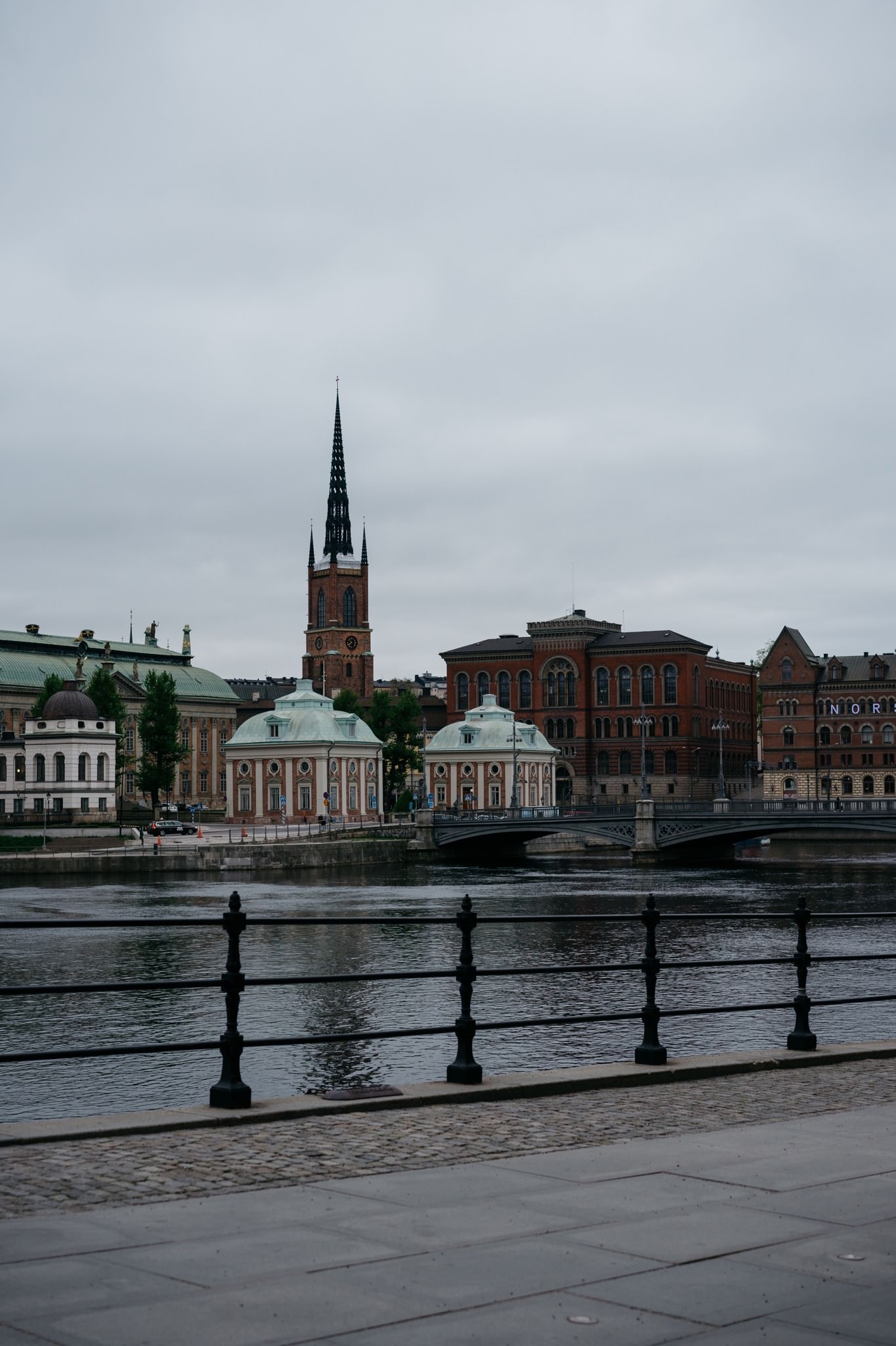 Stockholm skyline with church spire and bridge.