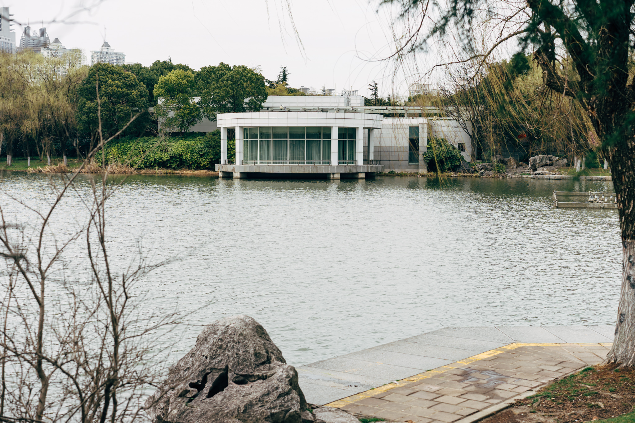 Modern white pavilion on a lake in Century Park, Shanghai.