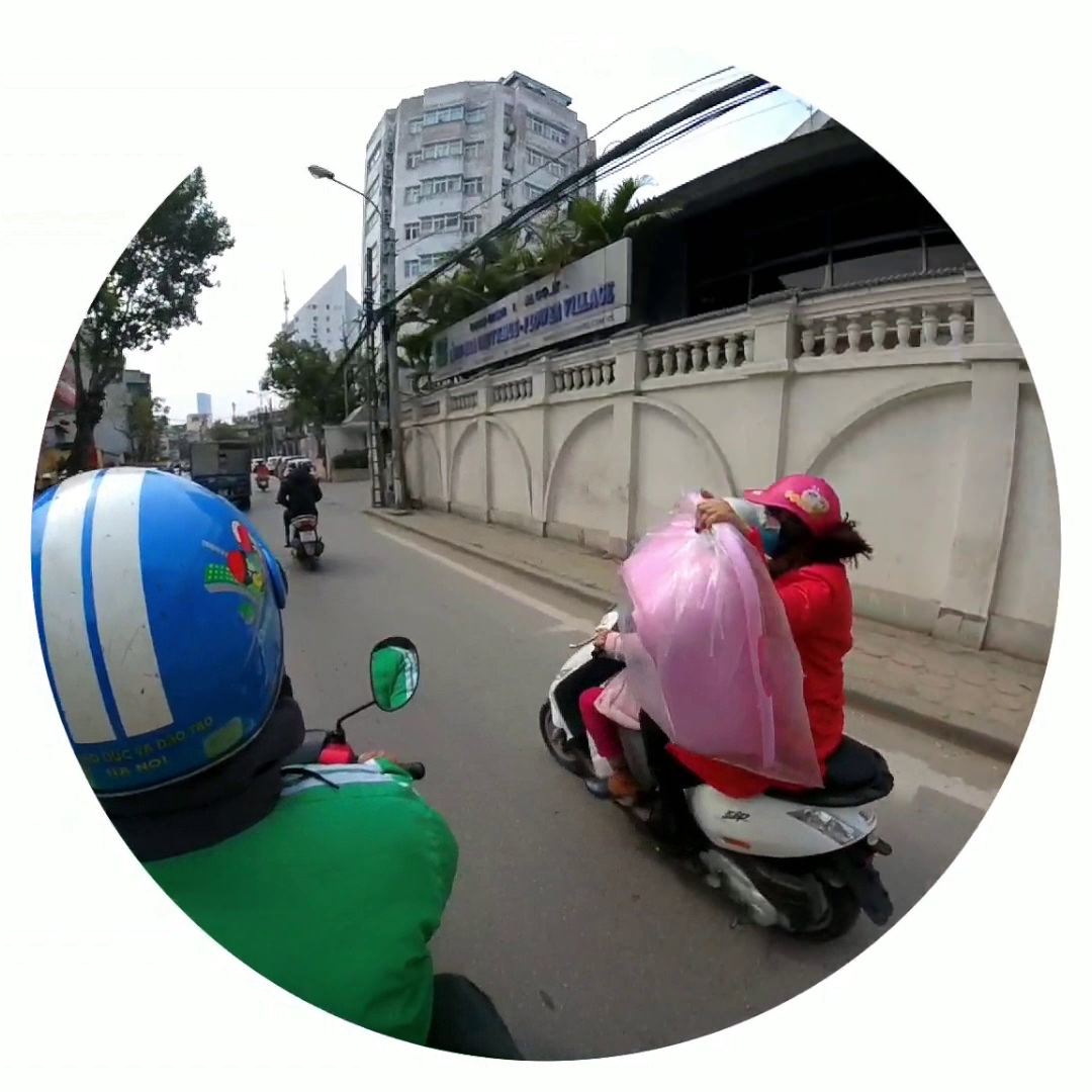 Motorbike in Hanoi, Vietnam, carrying a large pink bag.