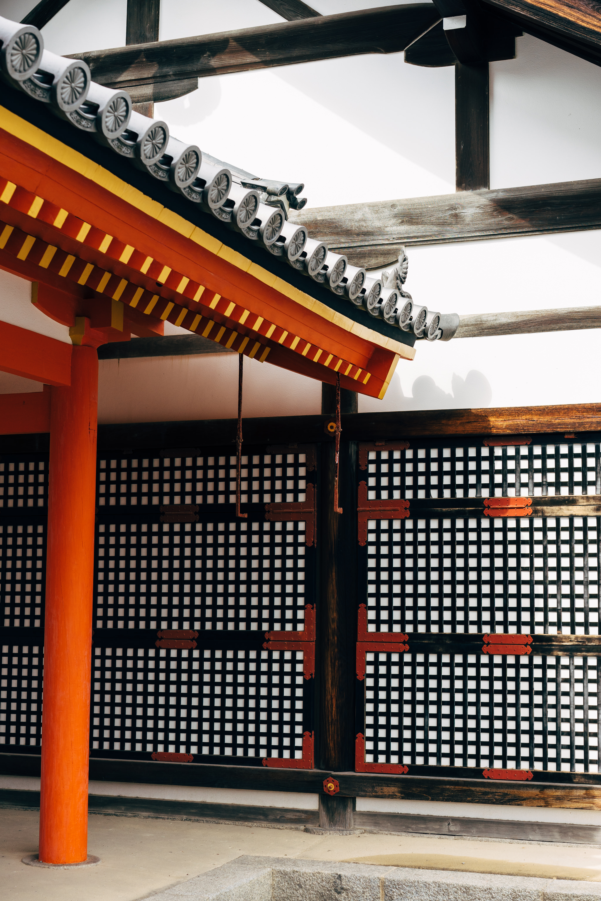 Kyoto Gosho Palace detail: red and gold eaves, black latticework wall.
