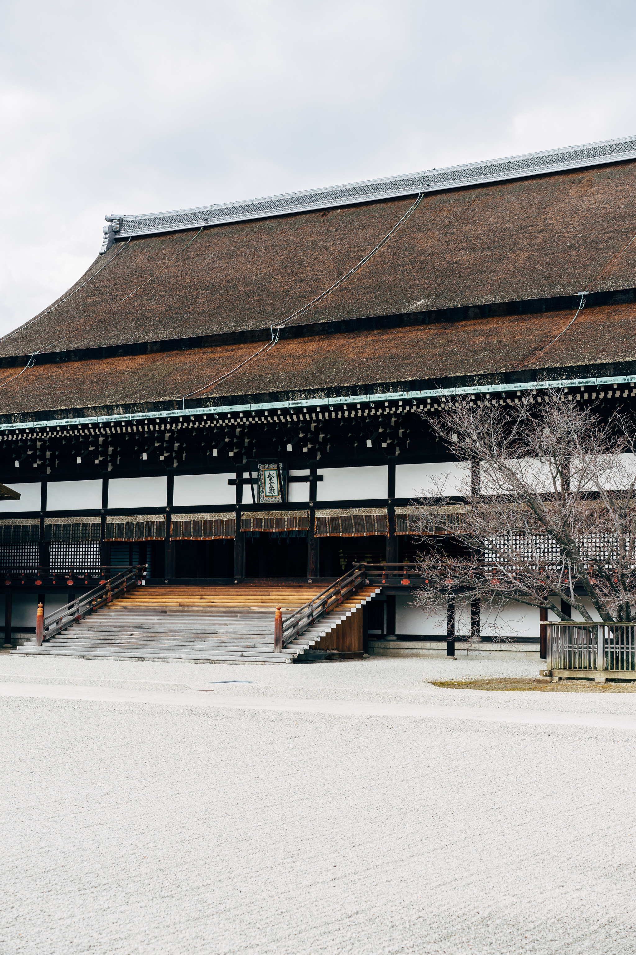 Kyoto Gosho Imperial Palace building with wooden stairs and thatched roof.