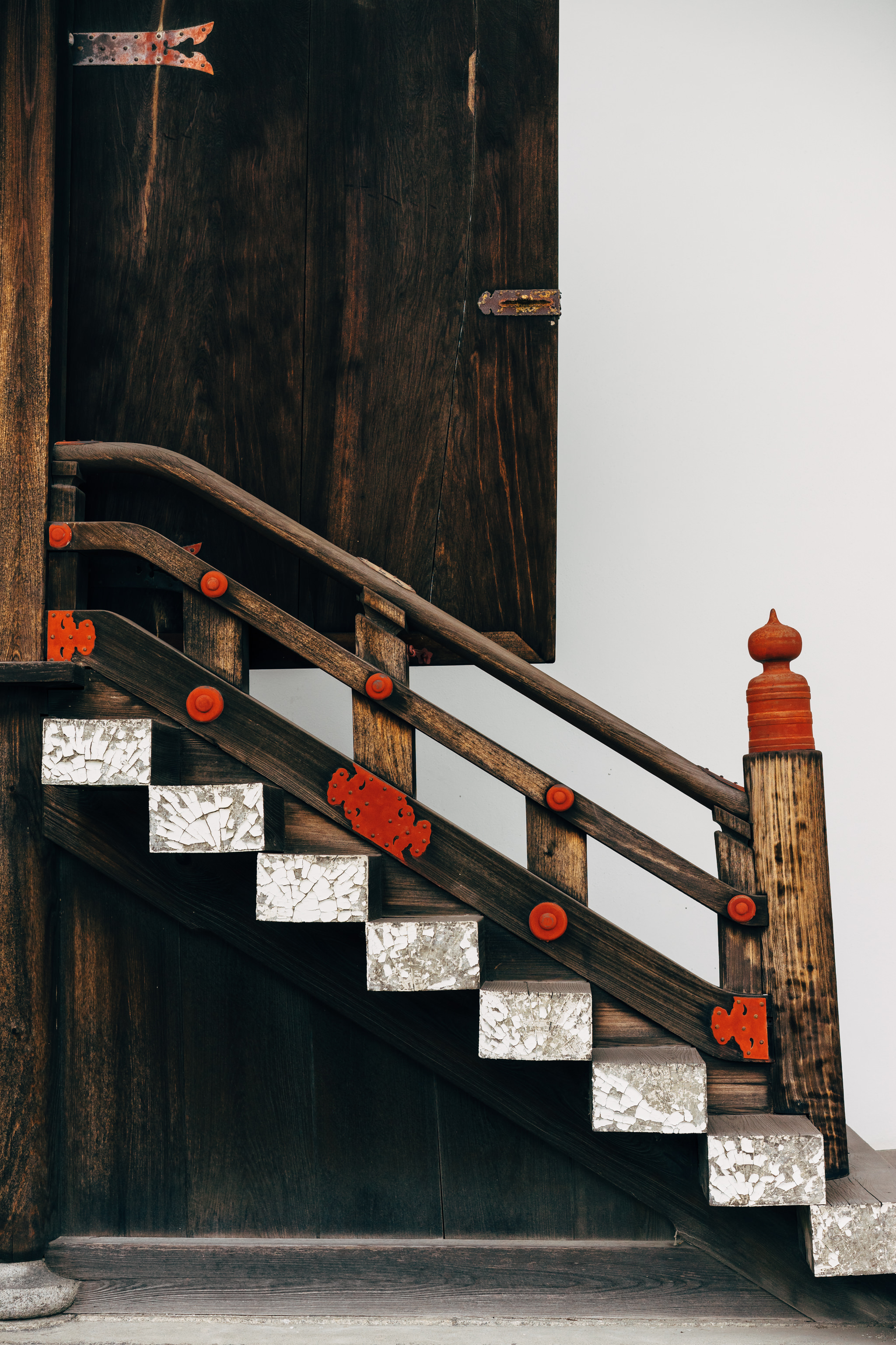 Wooden staircase with red accents at Kyoto Gosho in Japan.