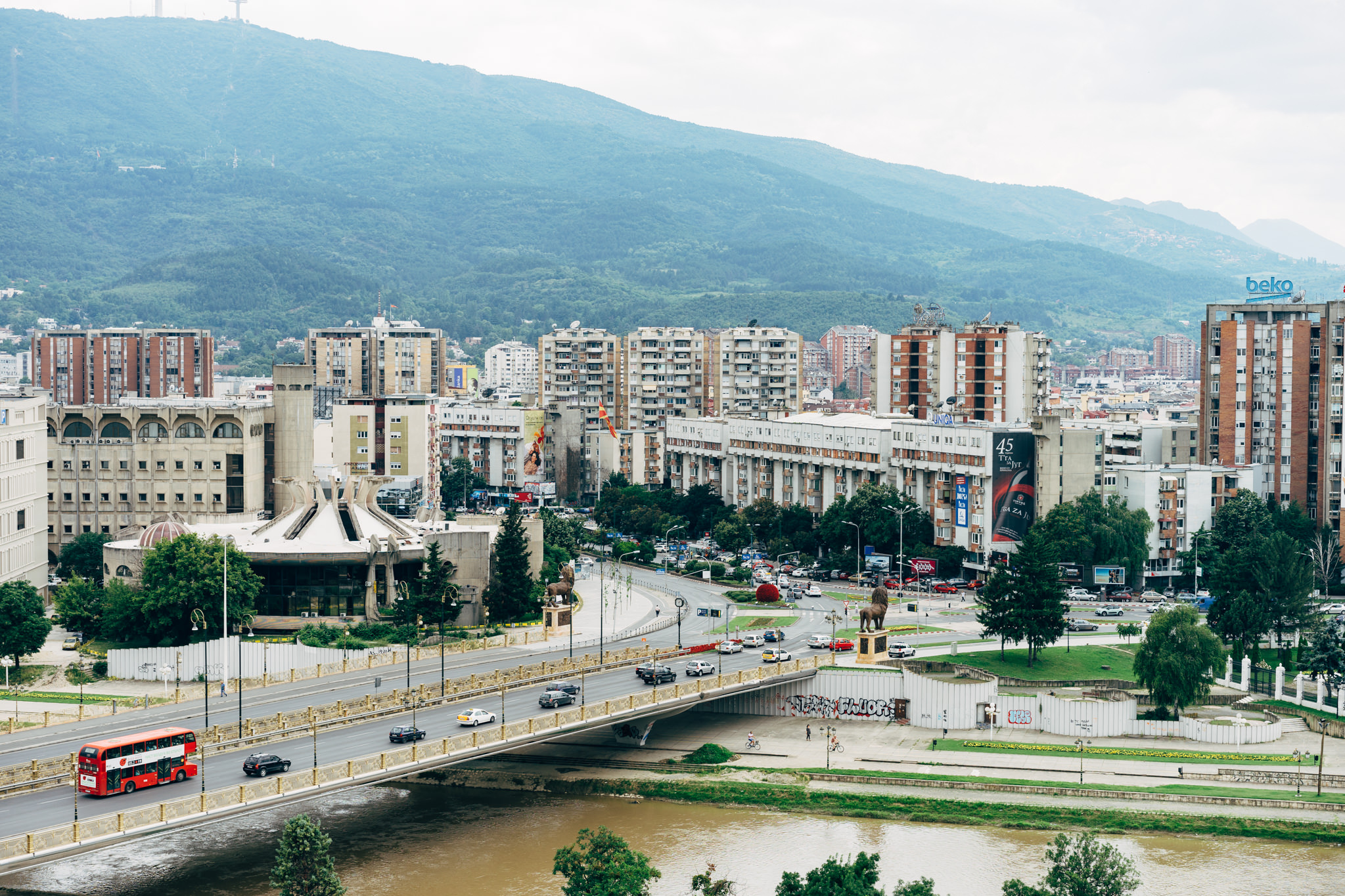 Goce Delcev Bridge in Bitola, Macedonia, with a red double-decker bus crossing it.