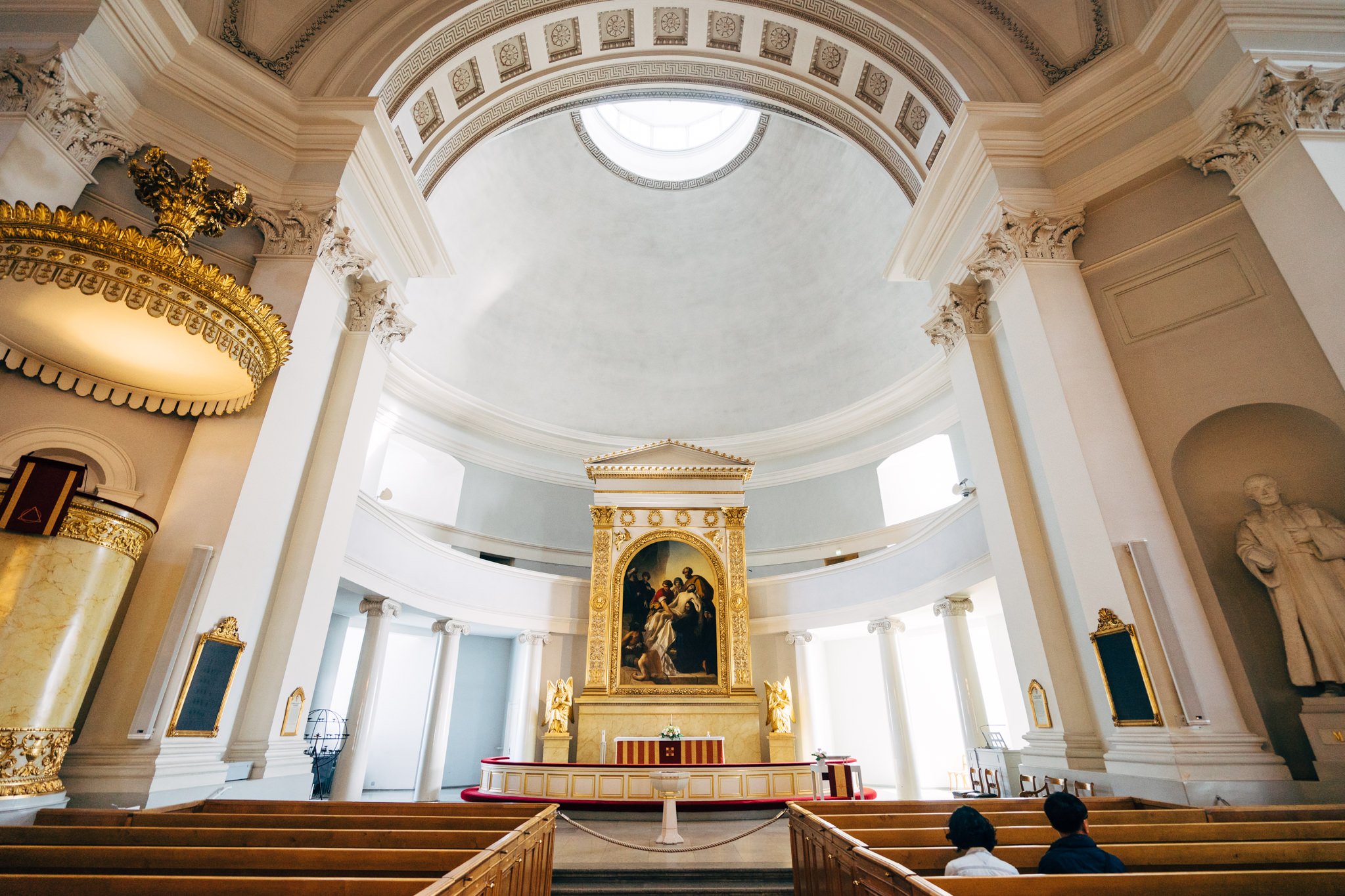Interior of Helsinki Cathedral, showing altar, pulpit, and pews.