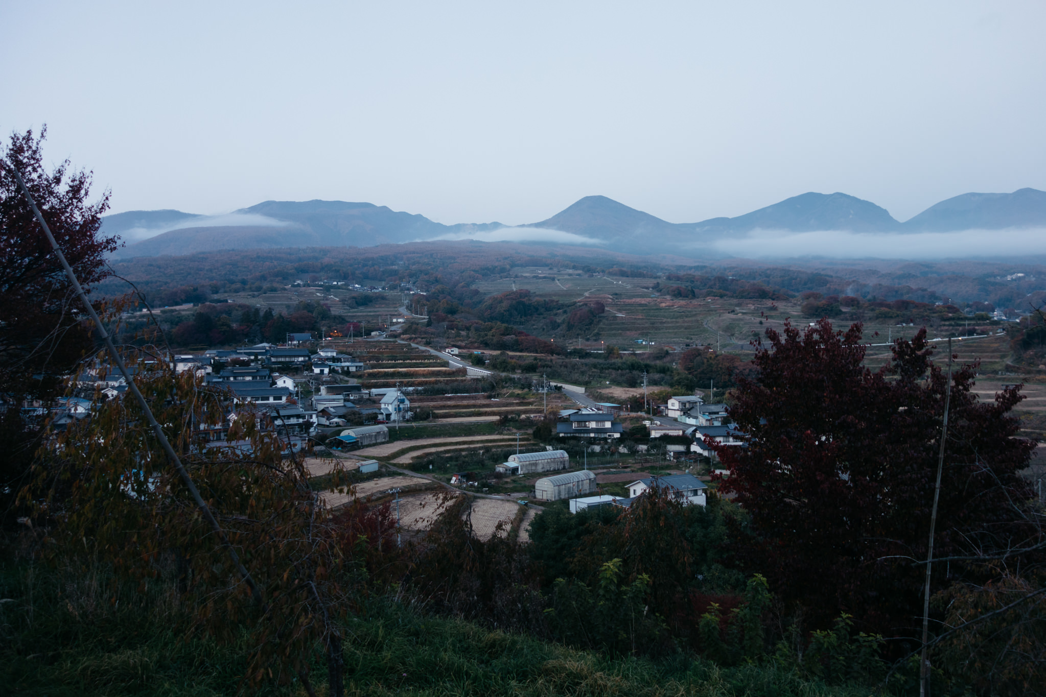 Evening view of Komoro Mountain and a village in the valley below.