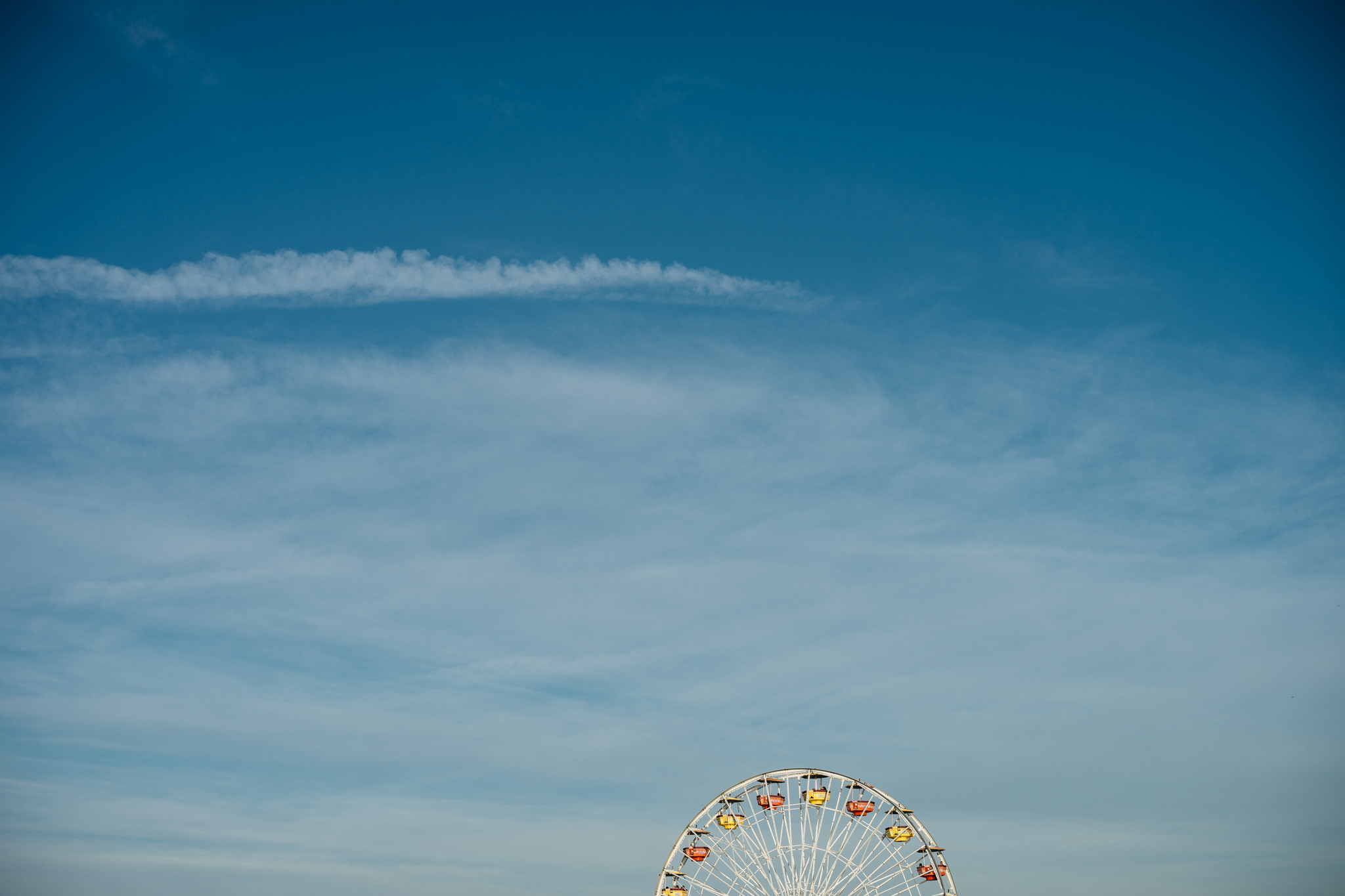 Ferris wheel against a blue sky.