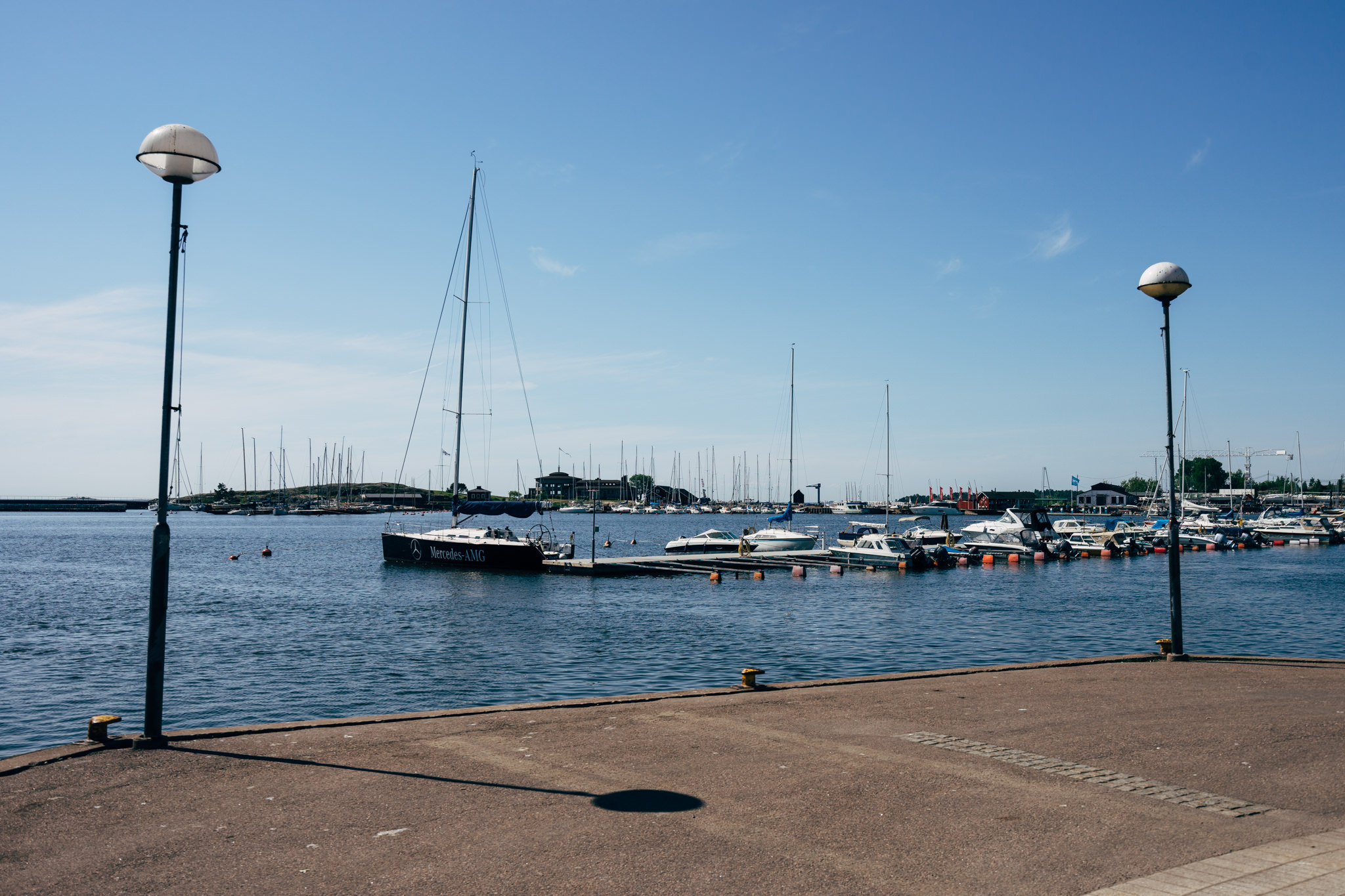 Helsinki harbor with boats moored at docks.