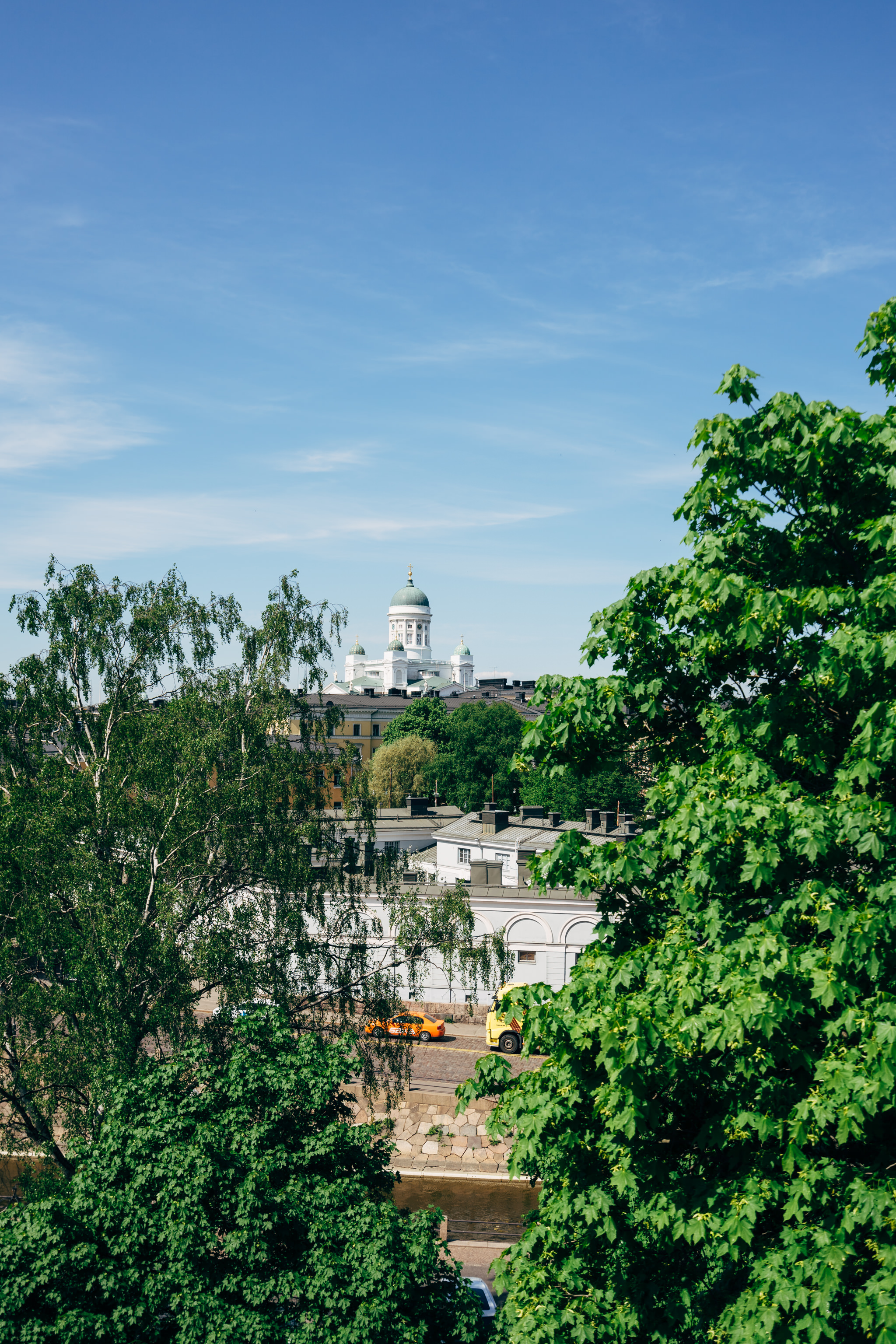 Helsinki cityscape with Helsinki Cathedral visible through trees.