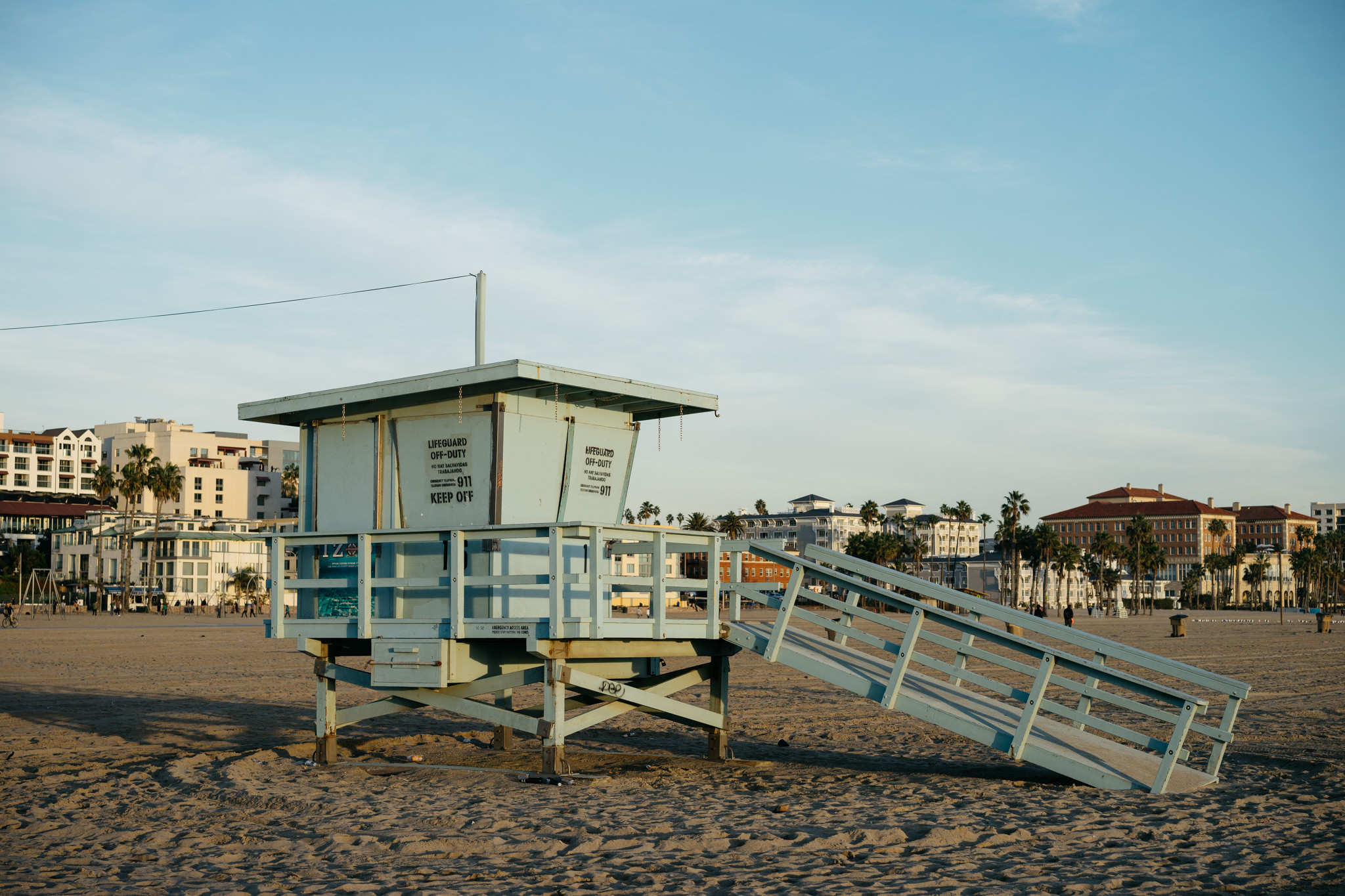 Beach lifeguard stand on sandy beach.