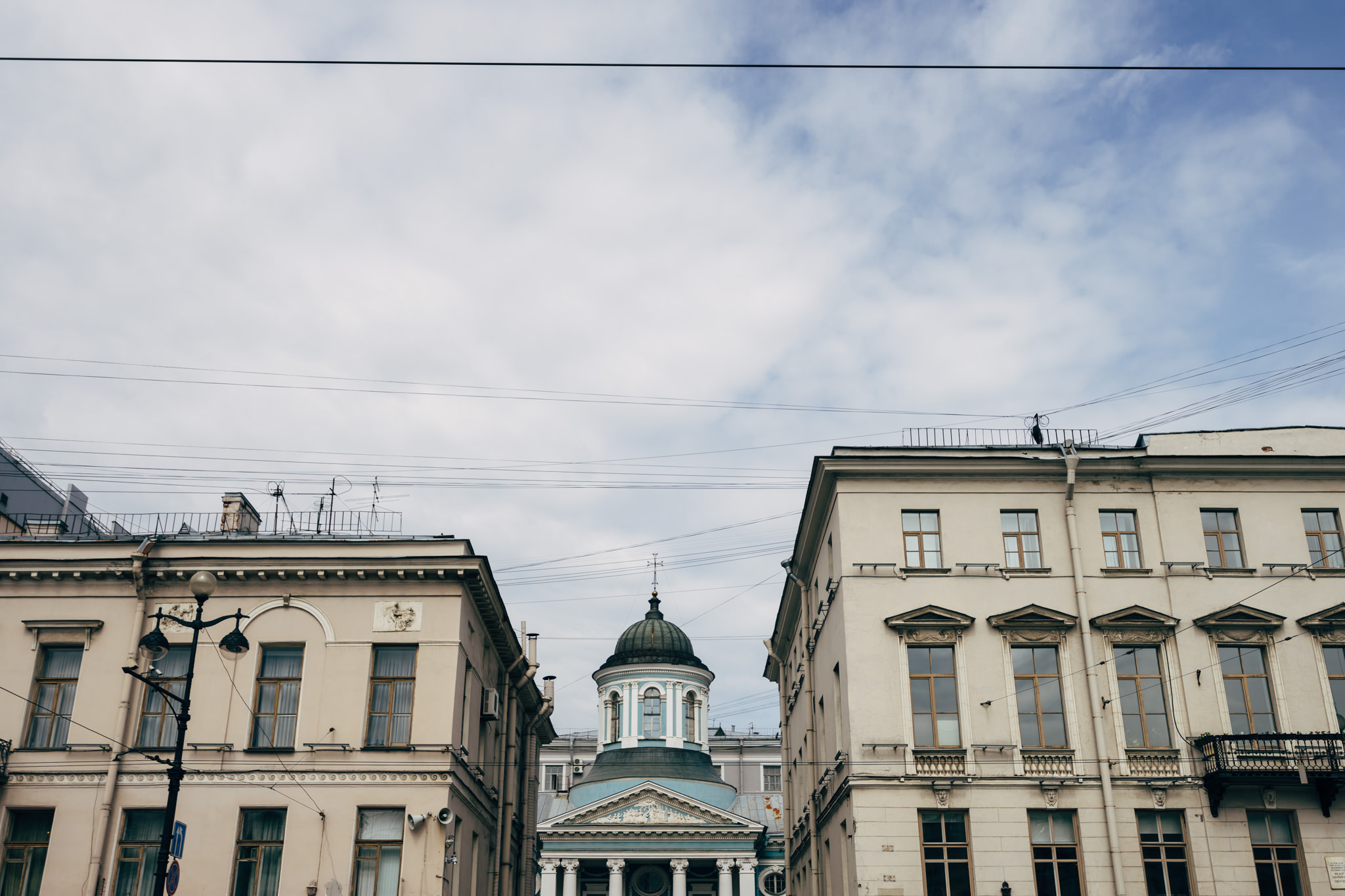 Saint Petersburg, Russia: buildings and church dome under cloudy sky.