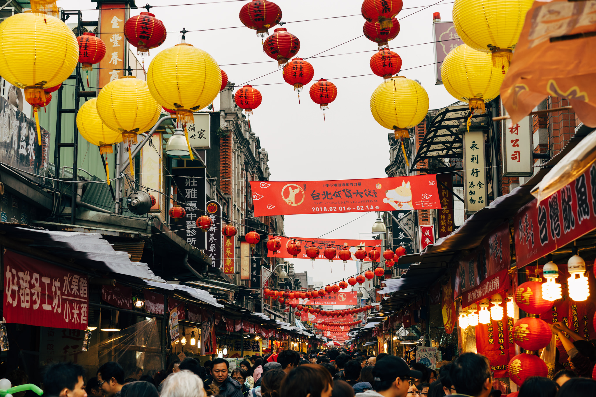 Taipei Lunar New Year market with red and yellow lanterns.
