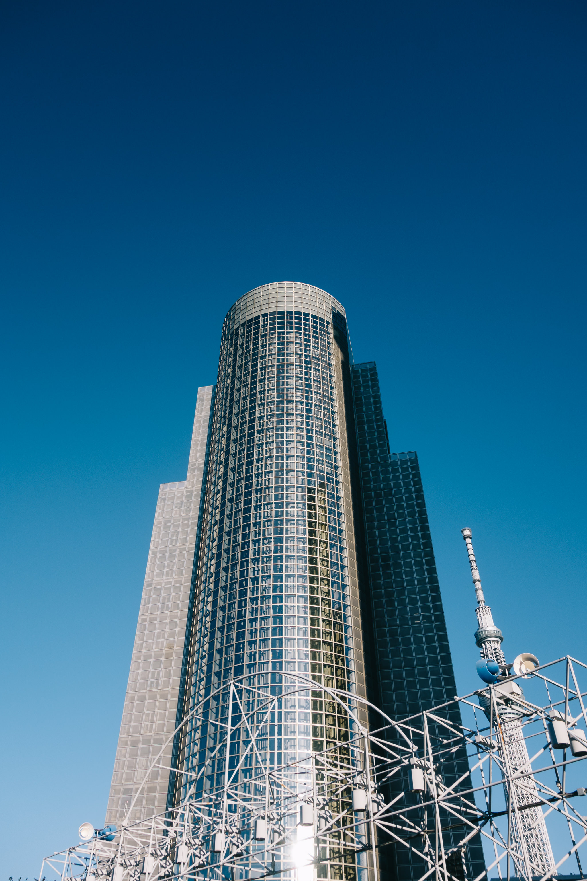 Tokyo skyscraper against a clear blue sky.