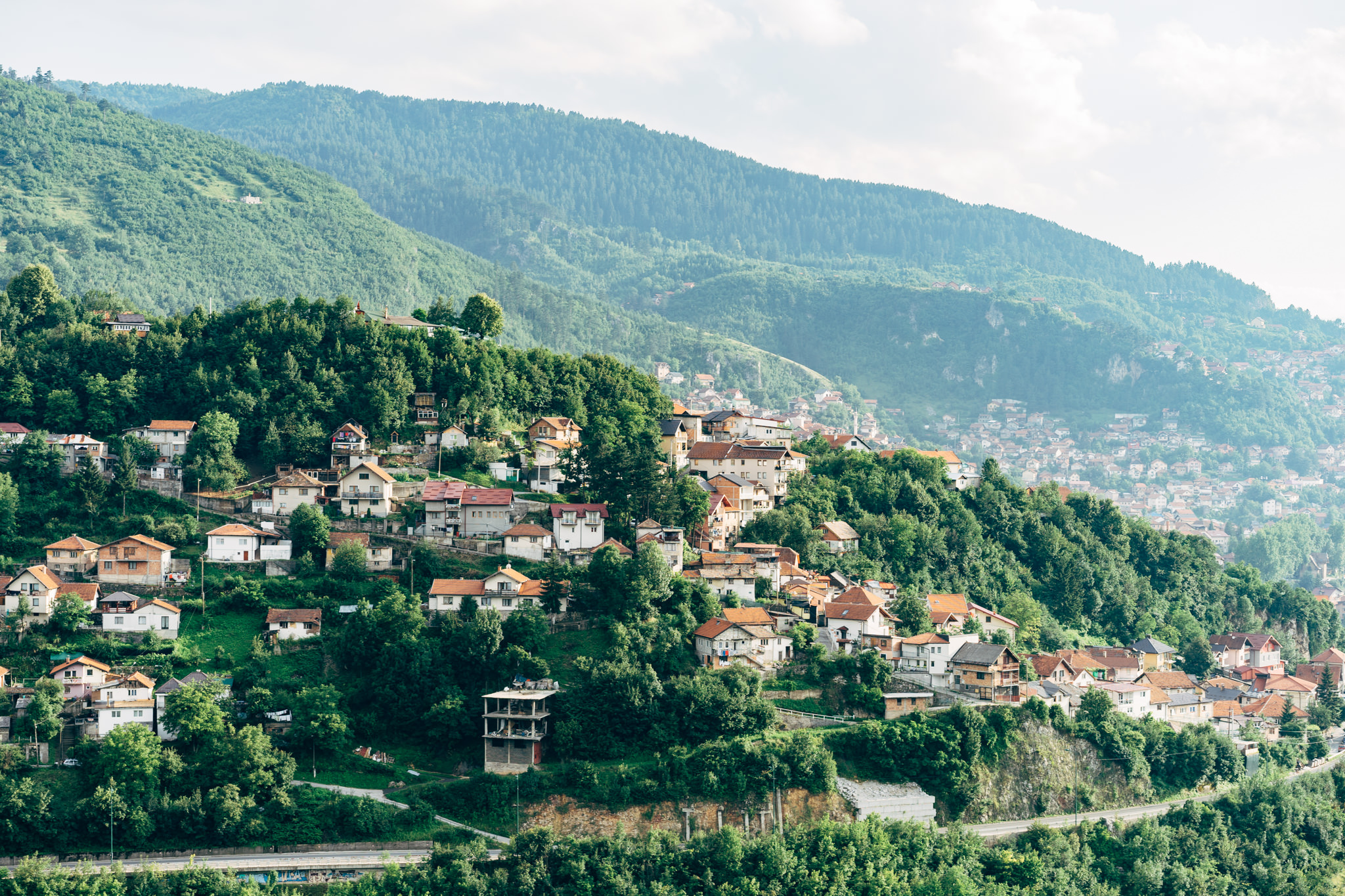 Houses on a lush green hillside in Bosnia and Herzegovina.