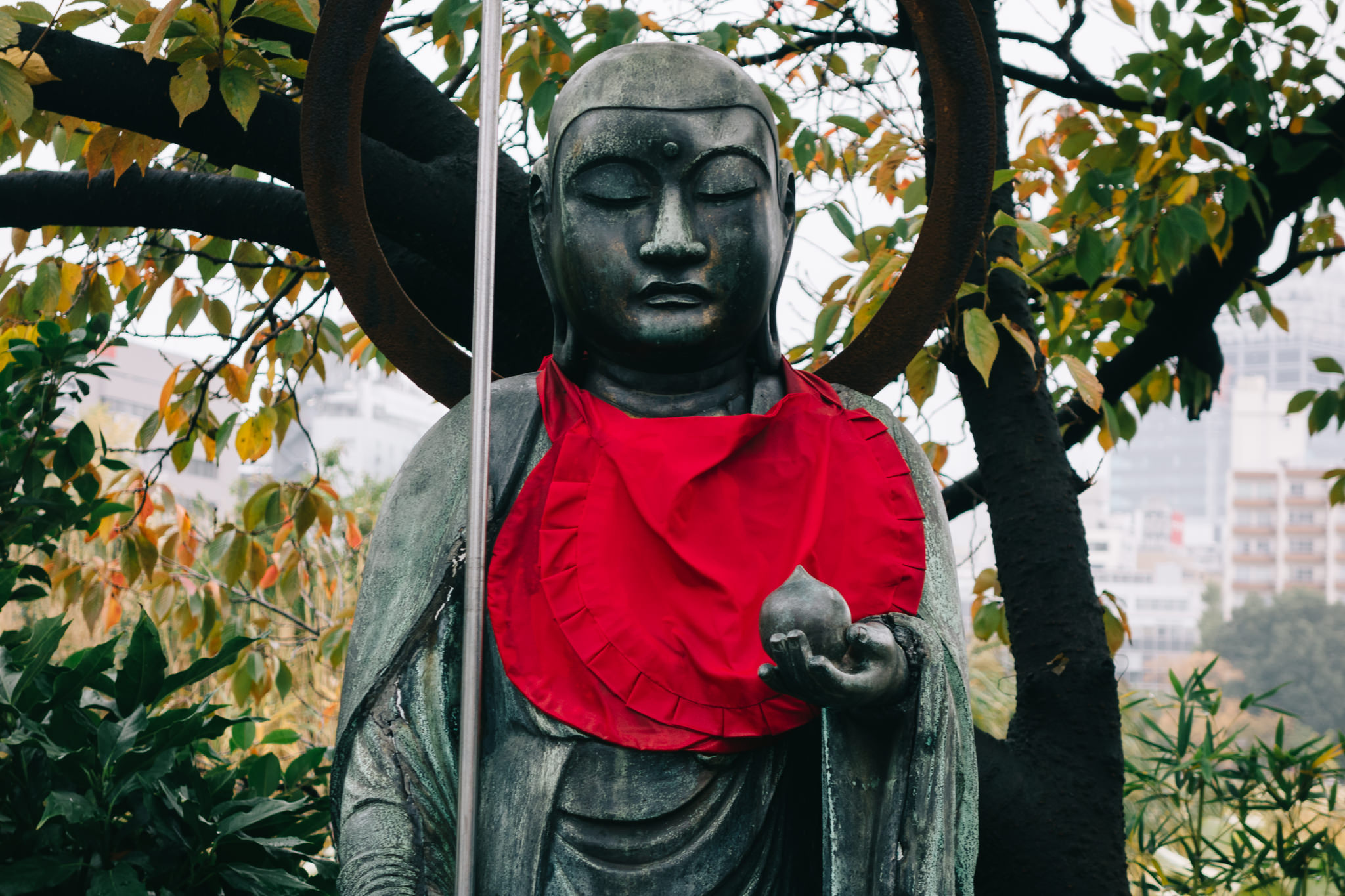Japanese Buddhist statue wearing a red cloth.