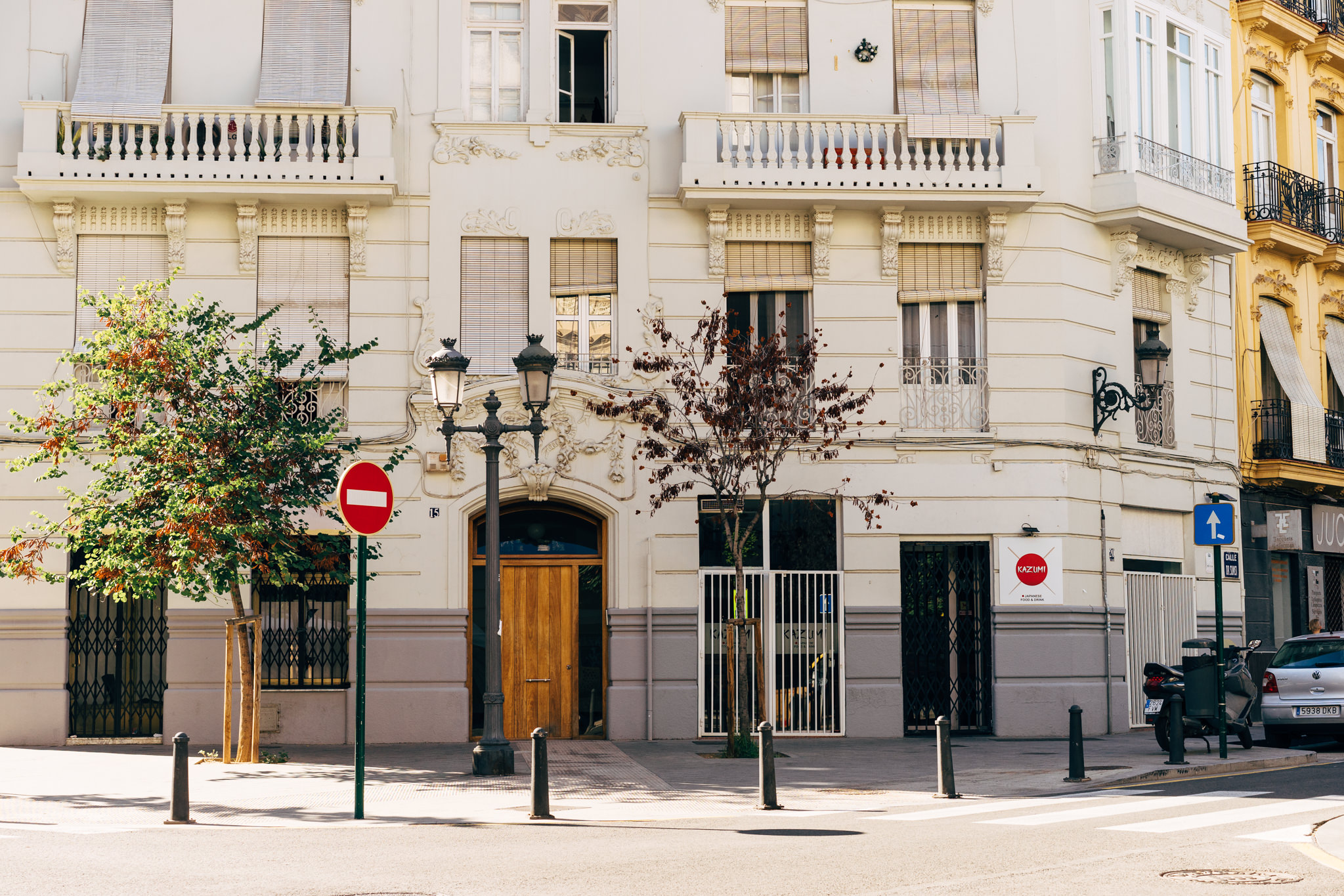 Valencia street scene with a white building, no entry signs, and a Japanese restaurant.