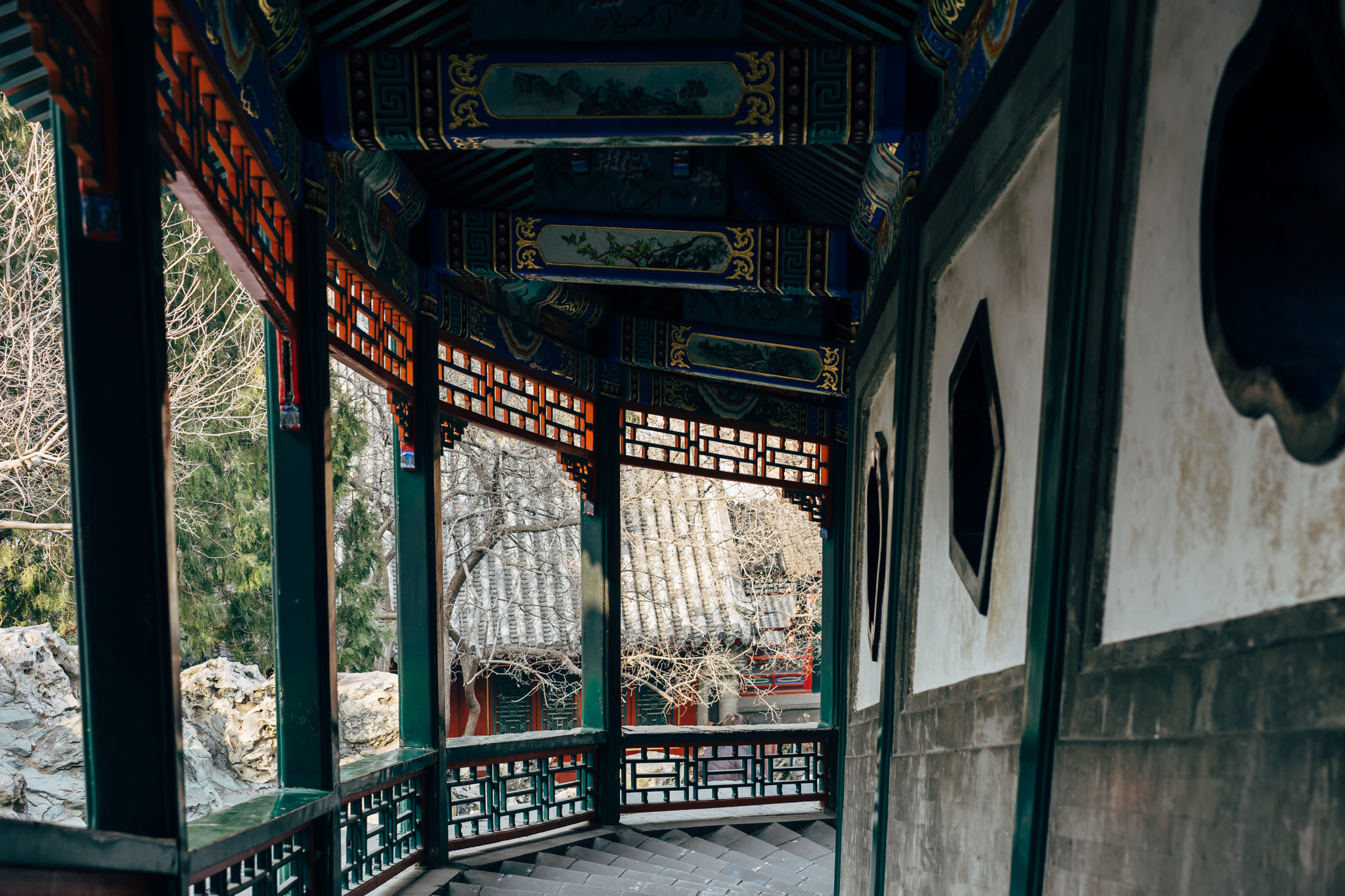 Intricate, painted, green and red wooden corridor in Beihai Park, Beijing.