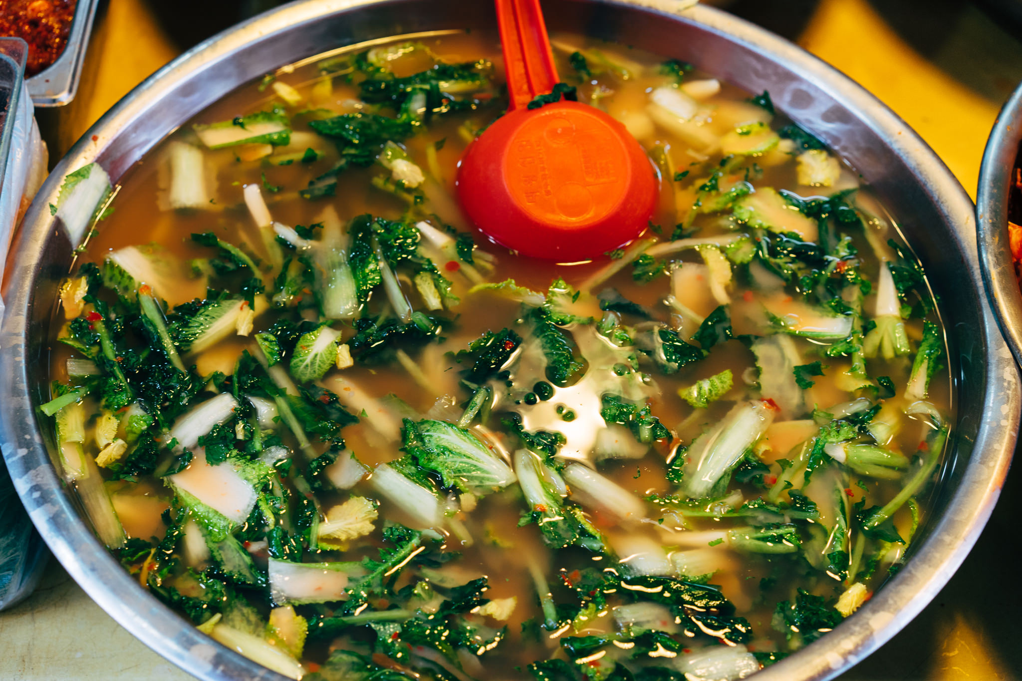 Large metal bowl of kimchi.