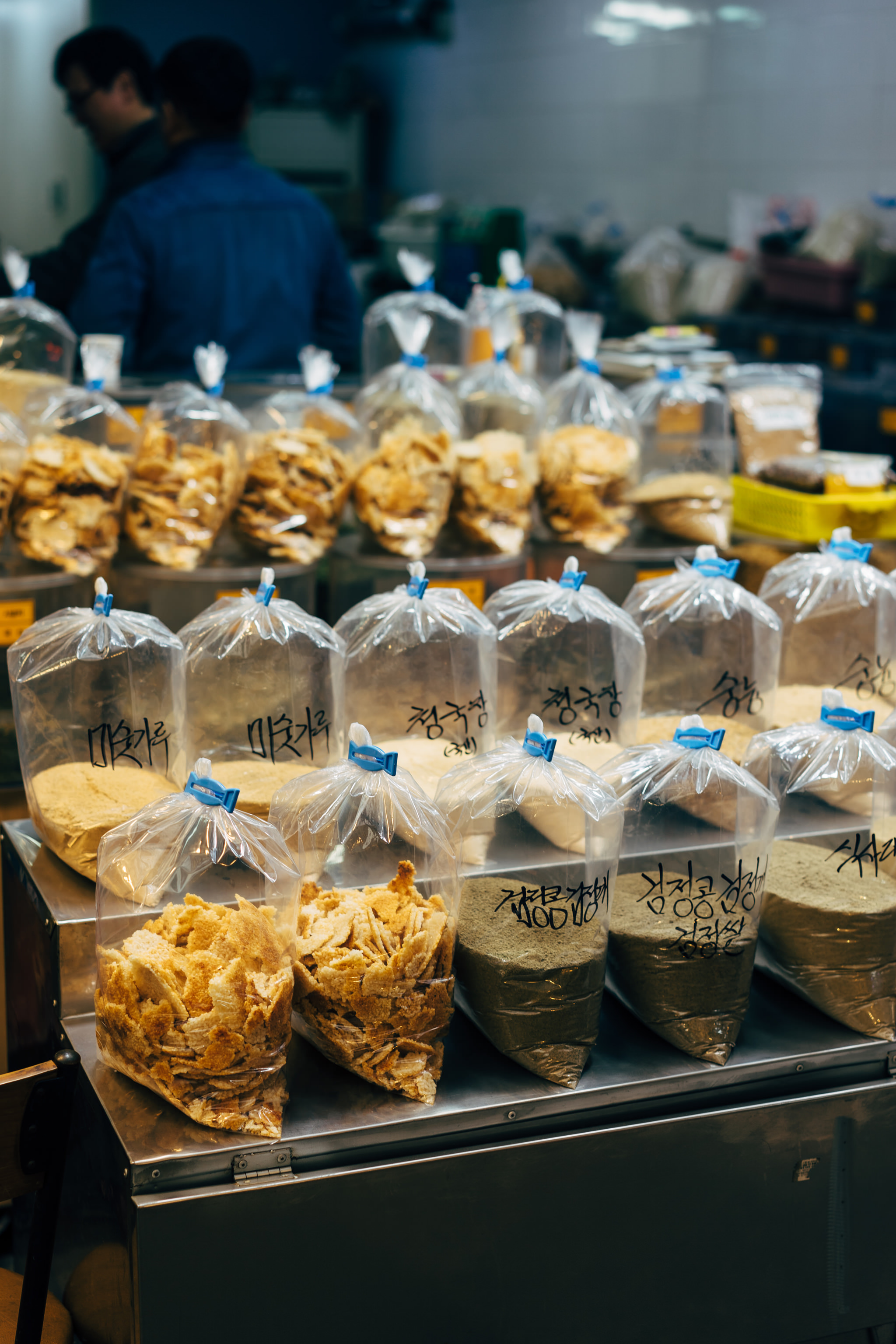 Busan market stall with various food items in clear plastic bags.
