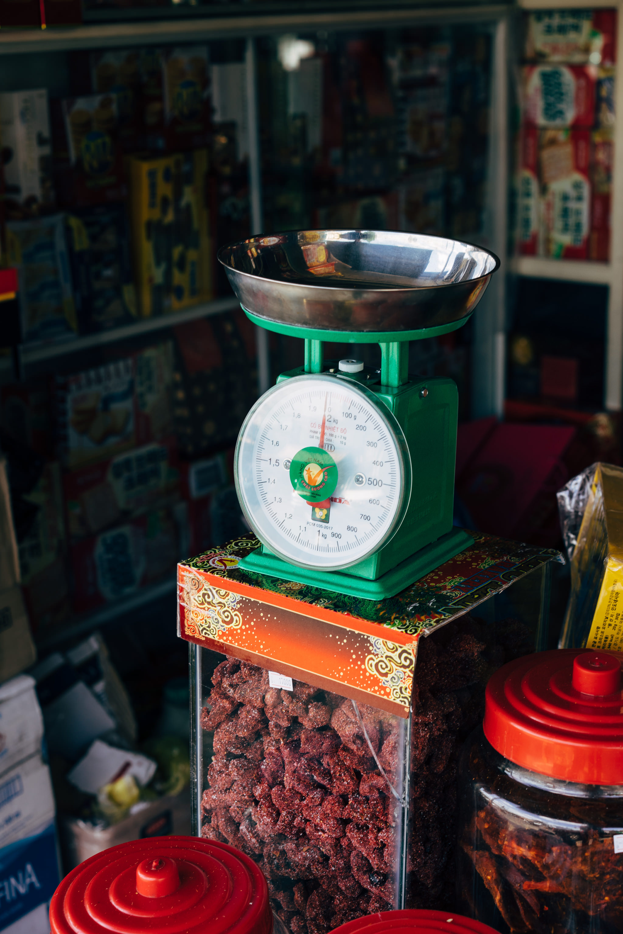 Green scale with silver bowl on a box of dried fruit.