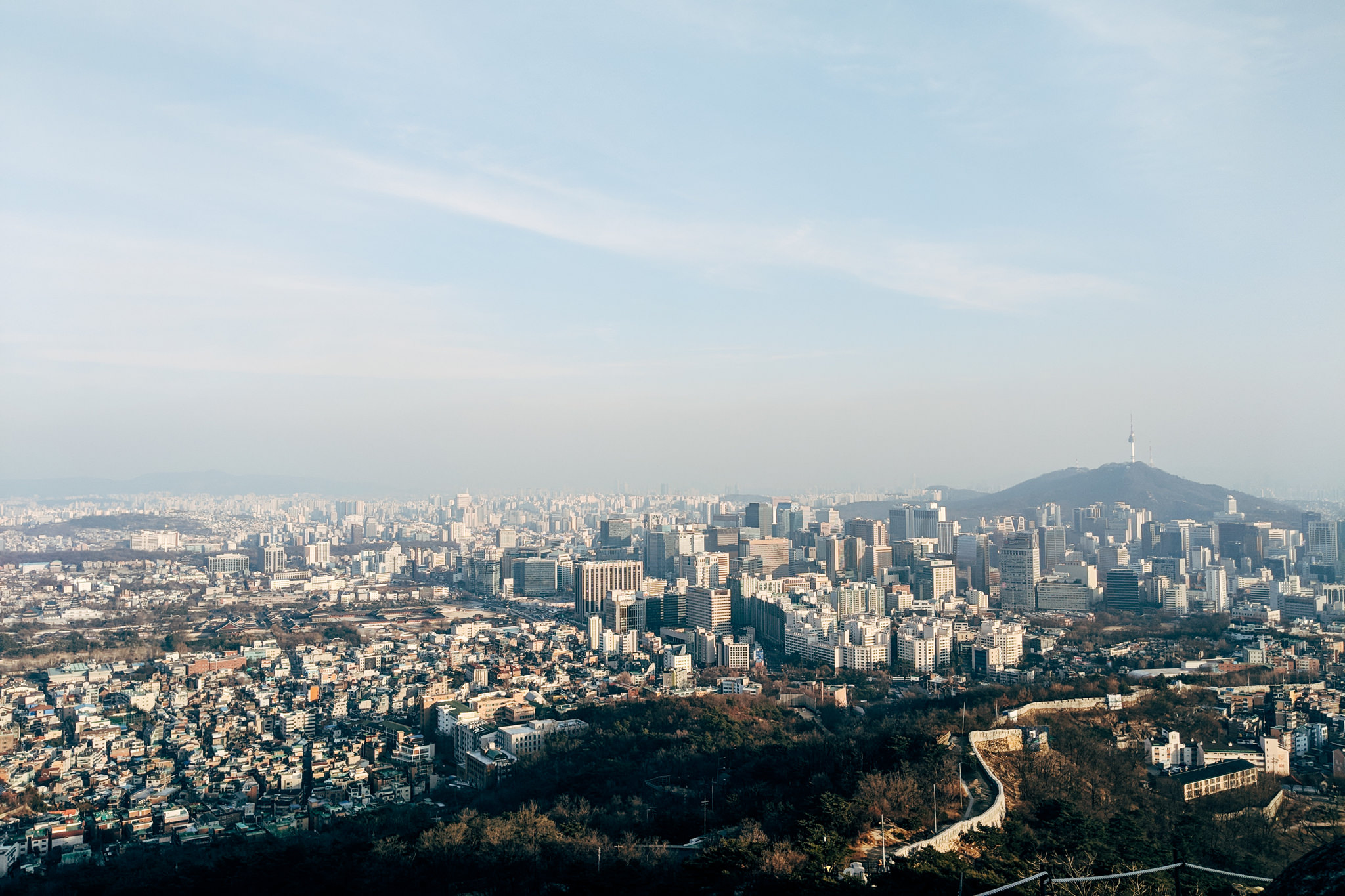 Aerial view of Seoul, South Korea, showing the cityscape and Inwangsan Mountain.