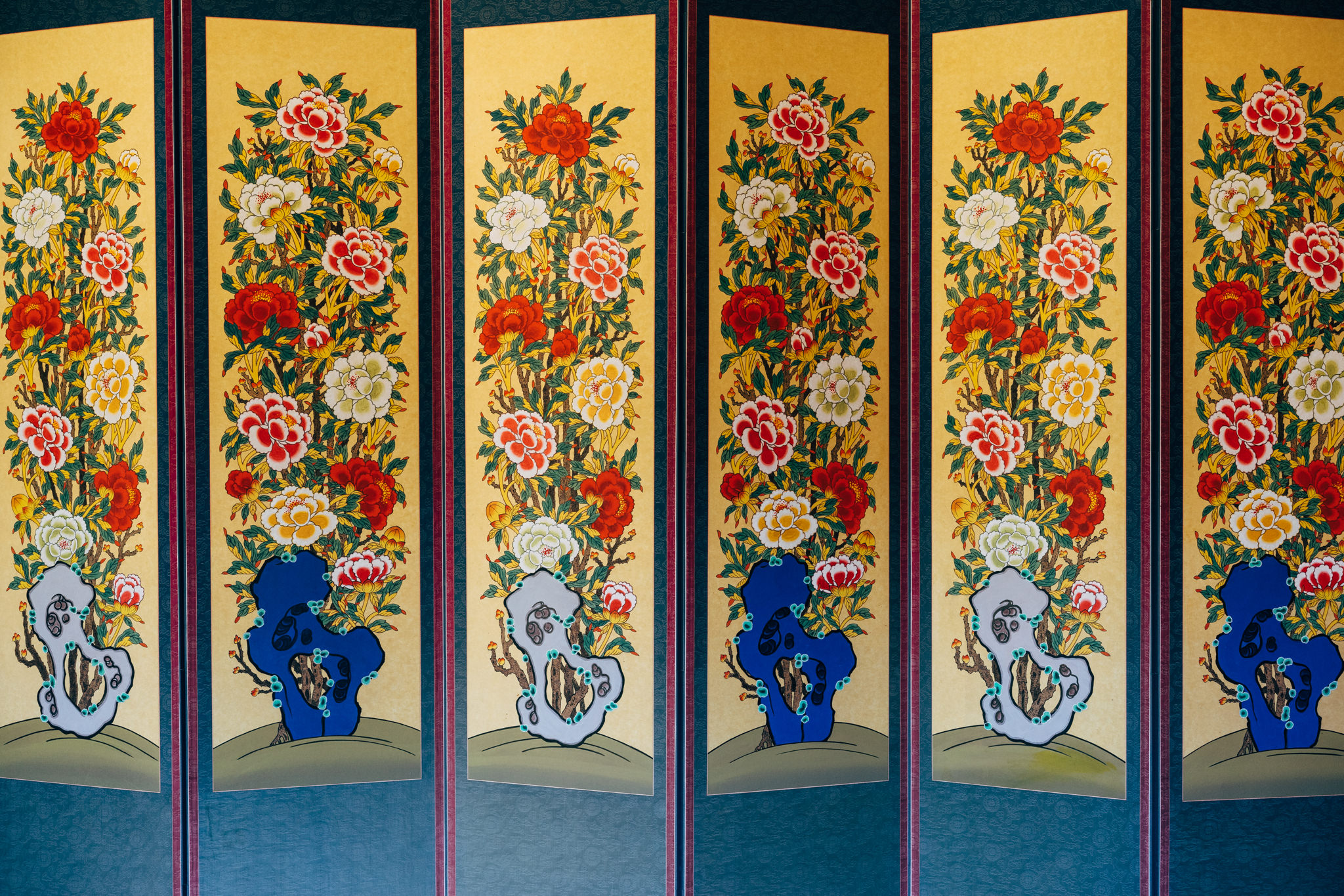 Folding screen with painted floral designs.