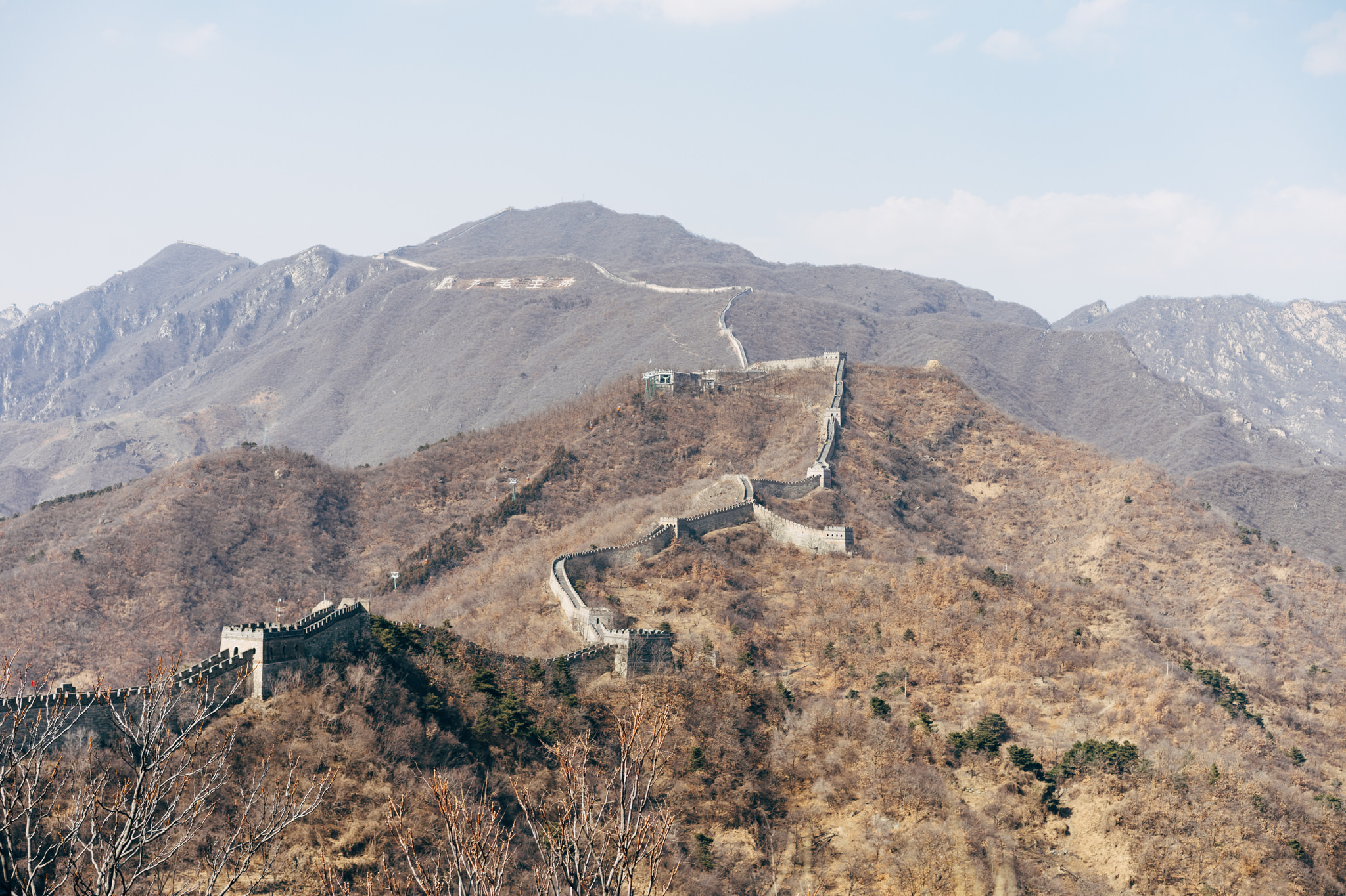 The Mutianyu section of the Great Wall of China winding across a mountain range.