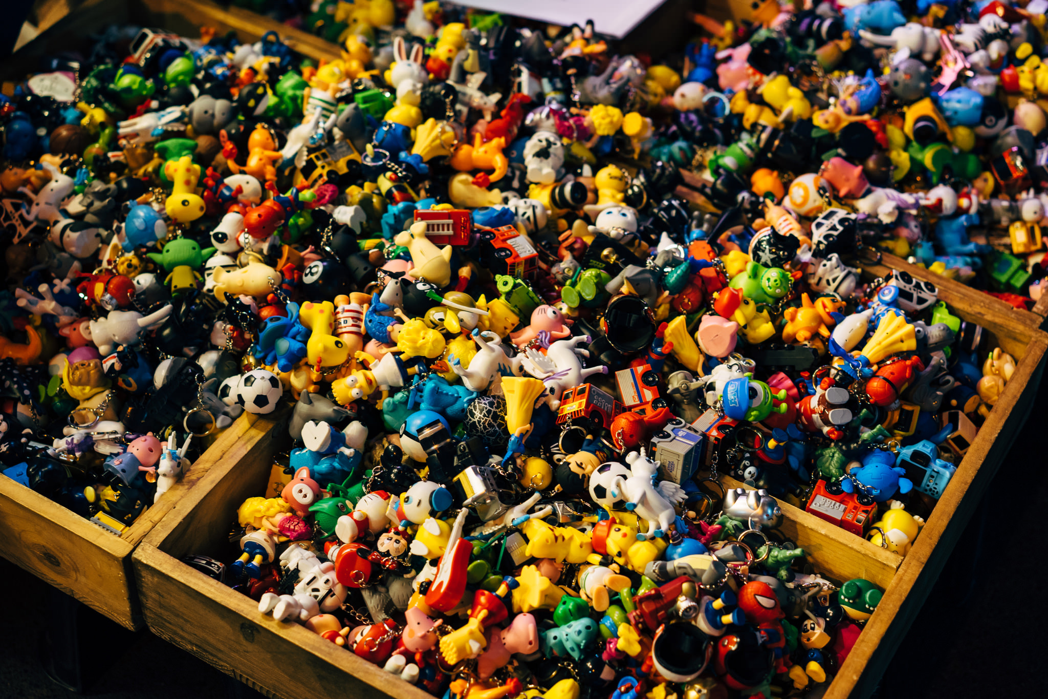 Wooden crate overflowing with colorful character keychains.