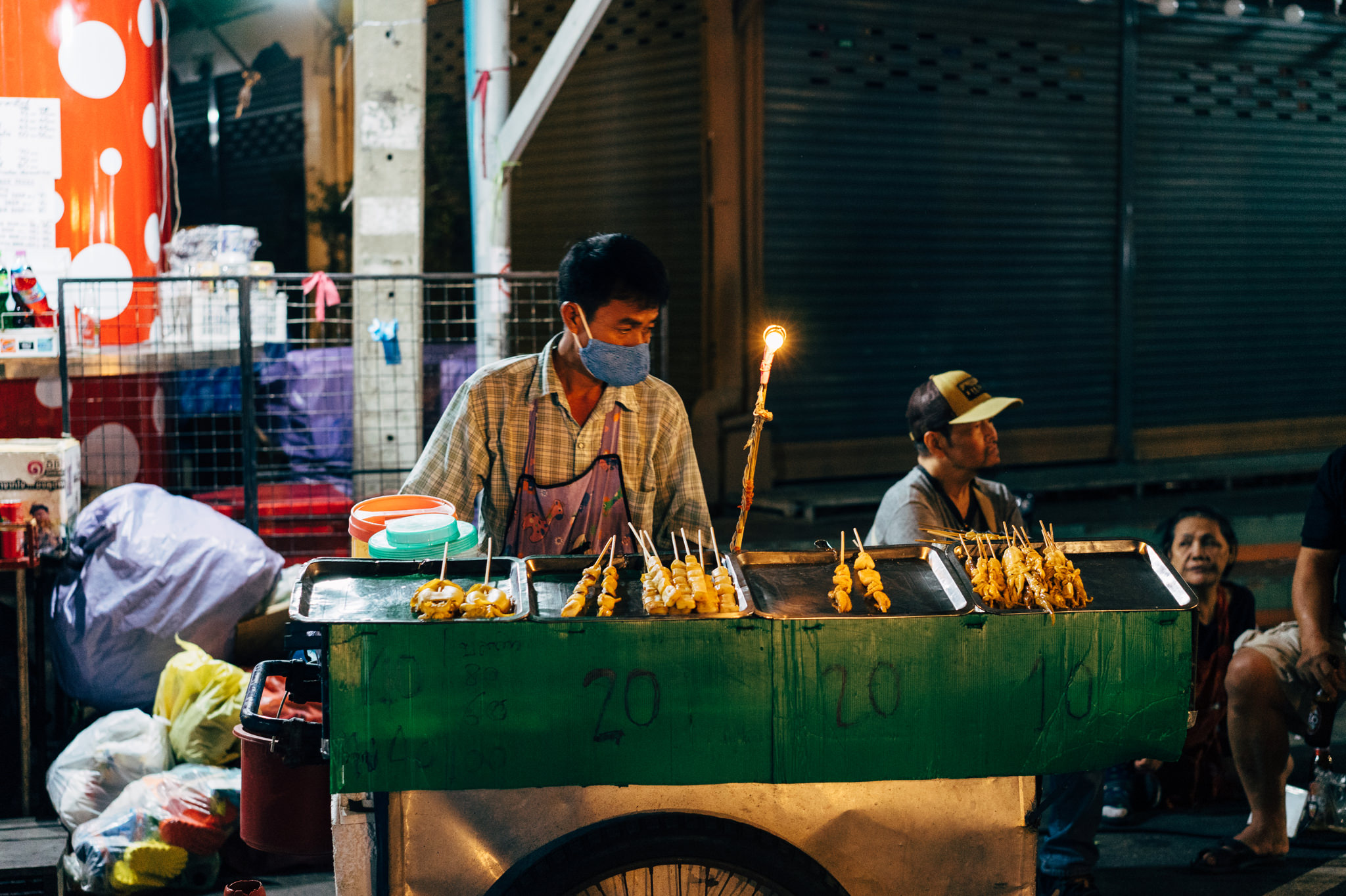 Bangkok street food vendor selling grilled skewers.