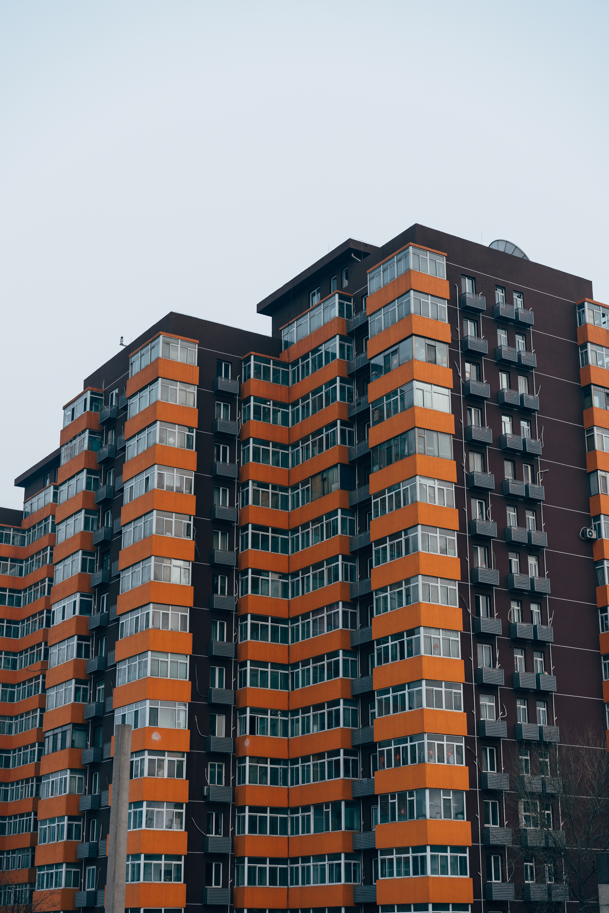 Beijing apartment building with orange and dark brown exterior.