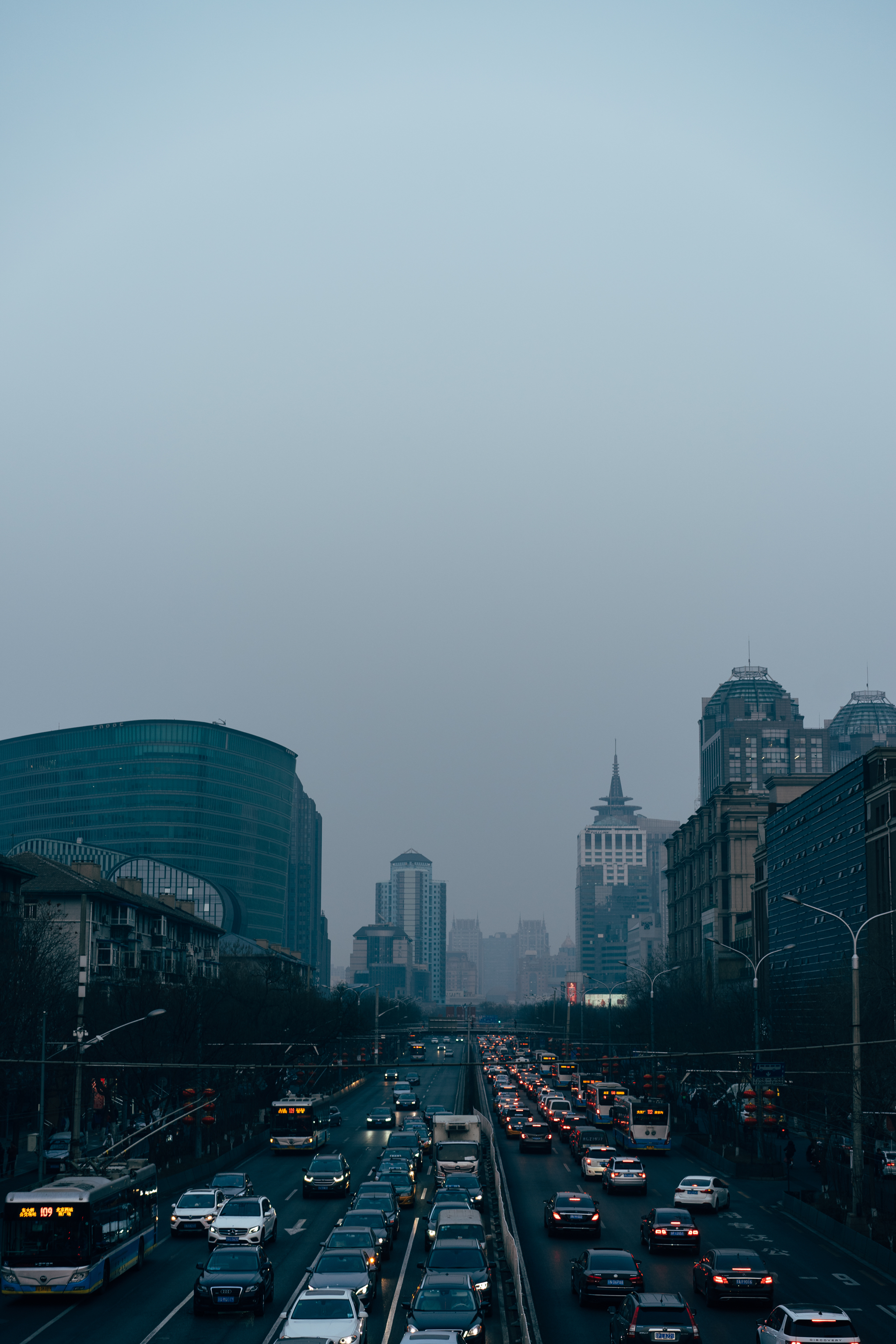 Beijing street at dusk, traffic jam with cars and buses.