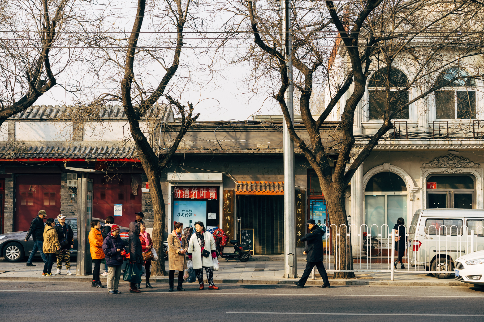 People waiting at a bus stop in Beijing, China.