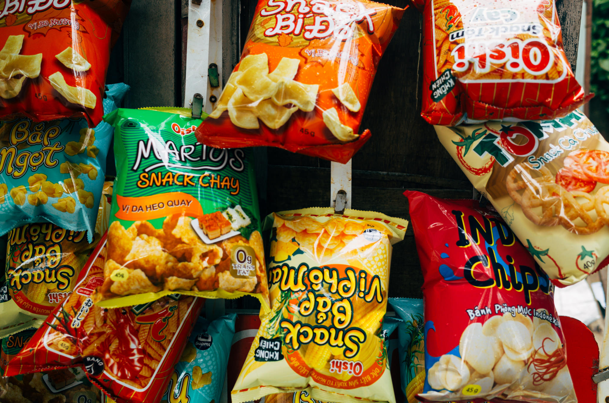 Variety of Asian snack chips in bags.