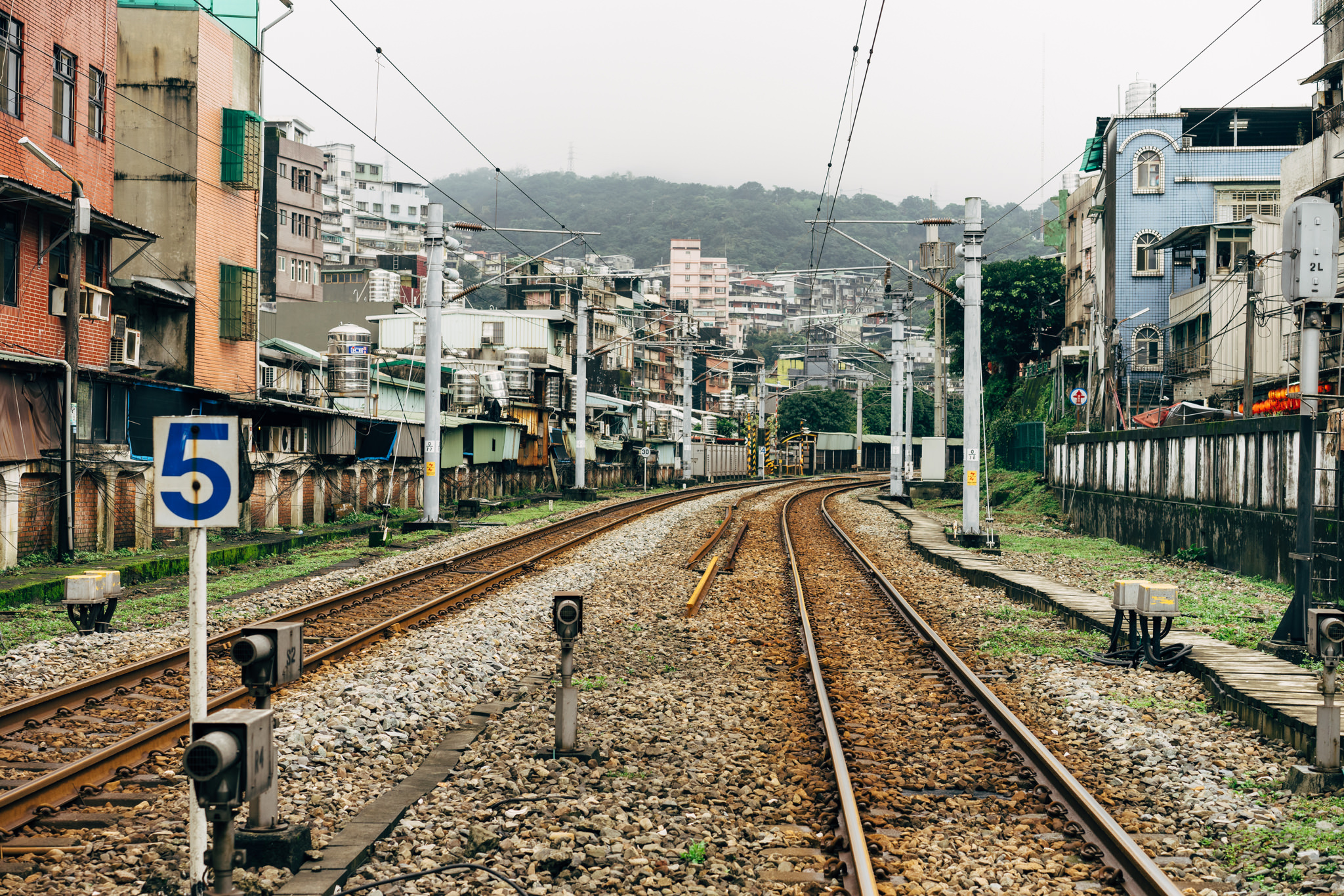 Train tracks curving through a residential area in Keelung, Taiwan.