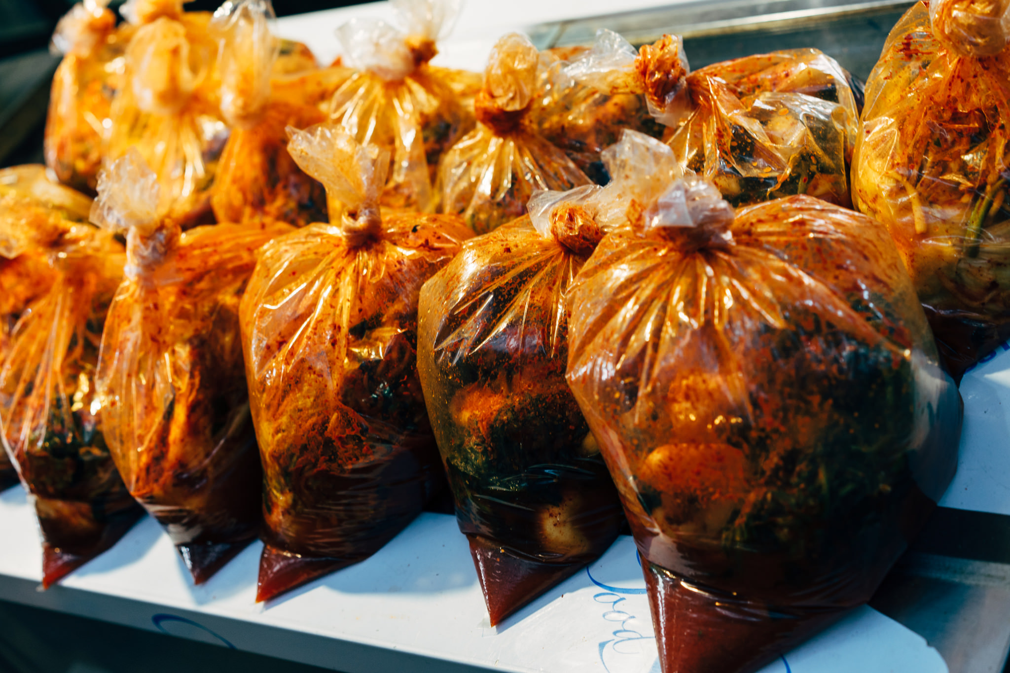Many bags of kimchi at a Korean market.