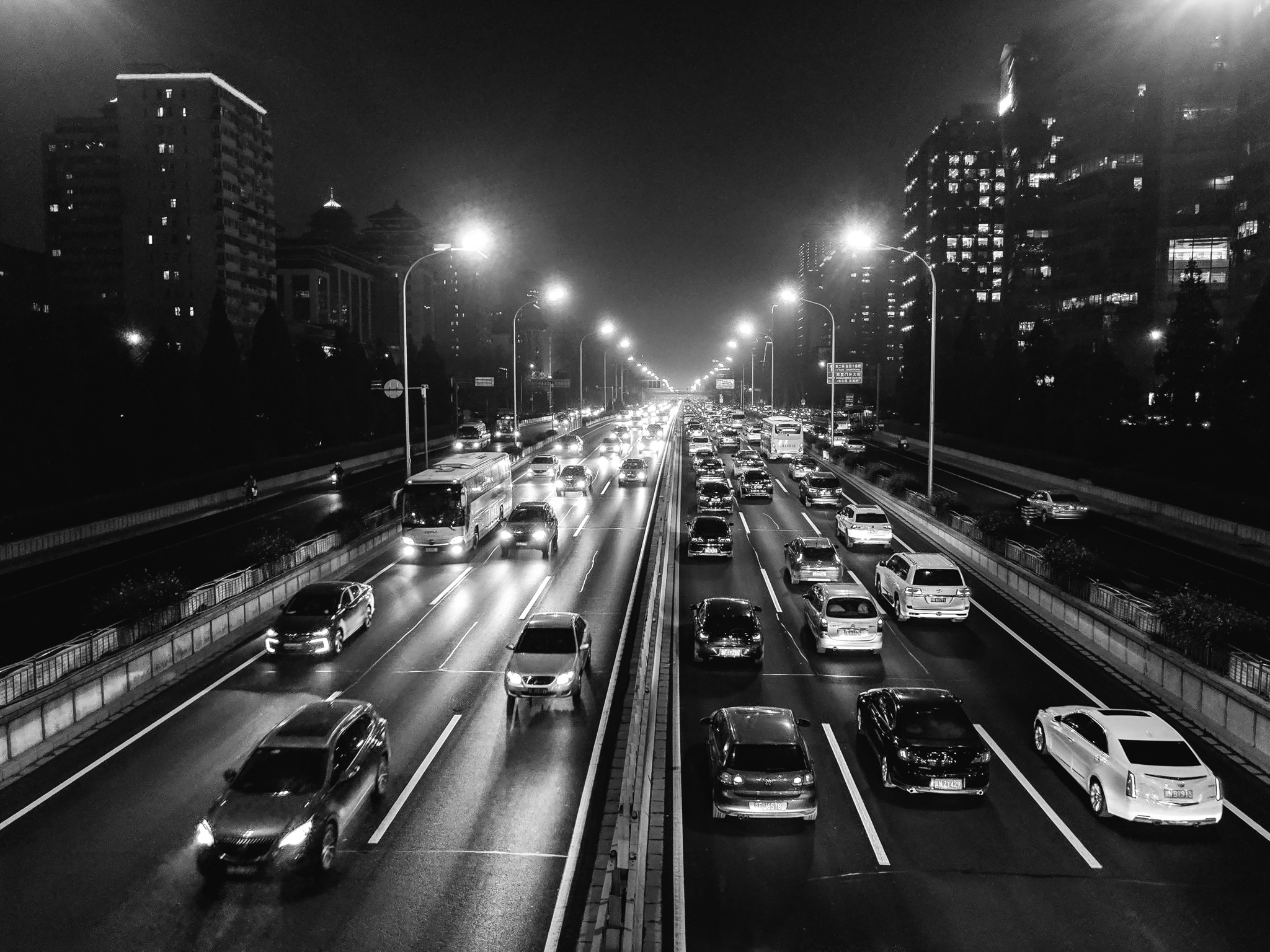 Black and white photo of night traffic on a highway in Beijing, China.